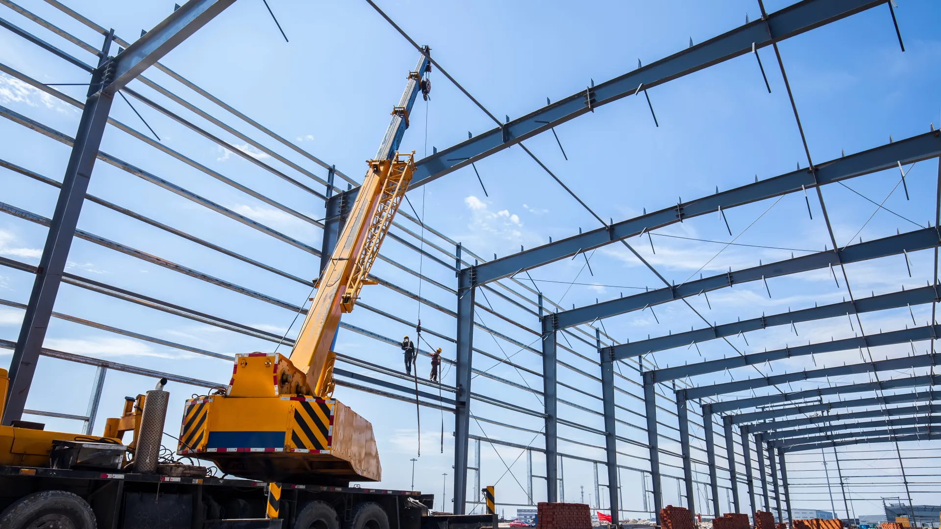 a crane lifting a large piece of metal