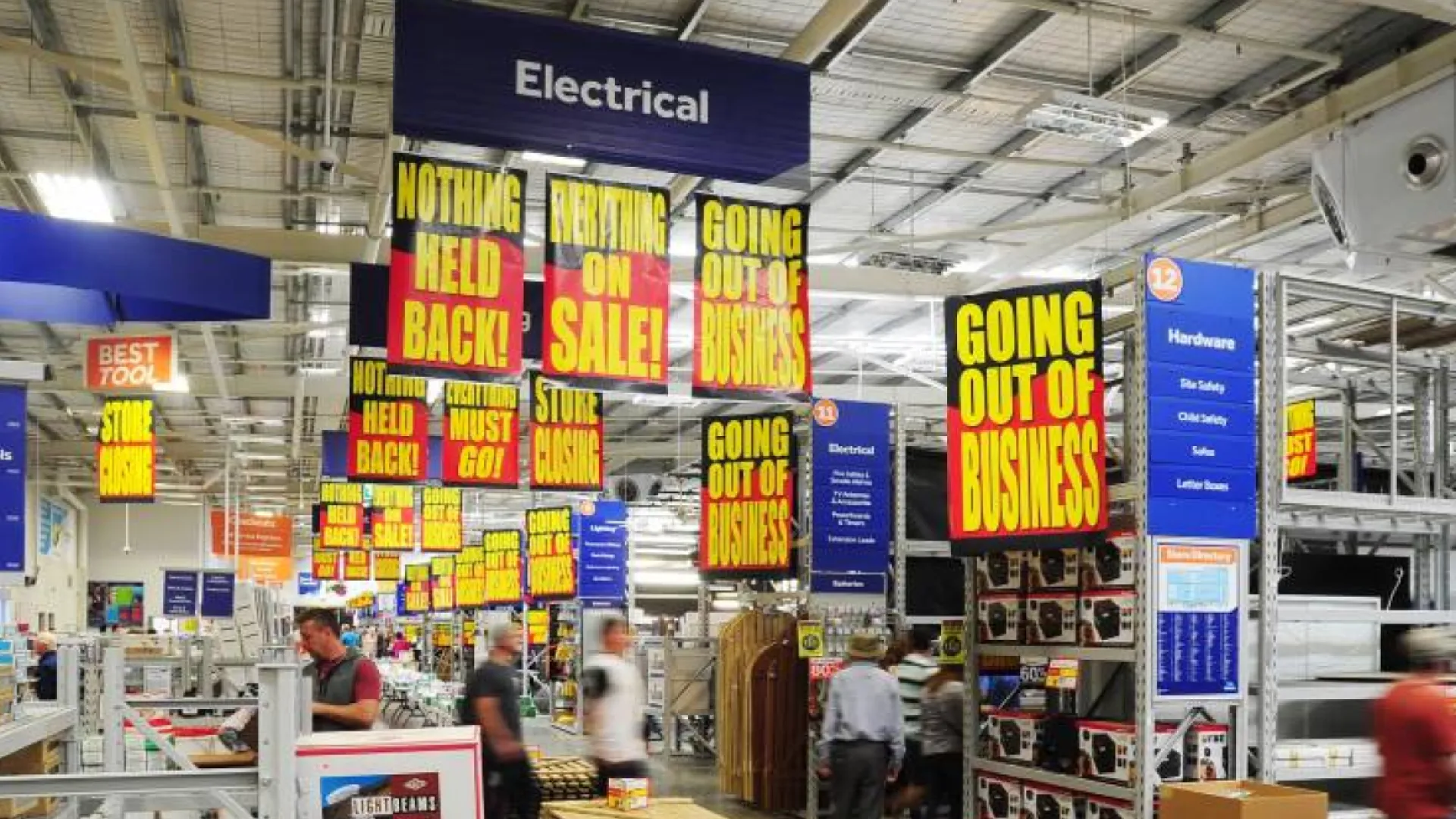 a large room with signs and people