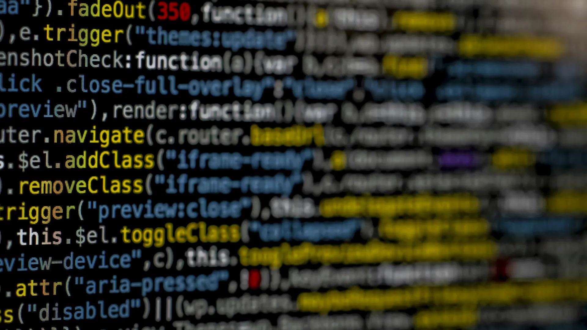 Close-up of colorful JavaScript code with functions, triggers, and class manipulation on a dark screen.