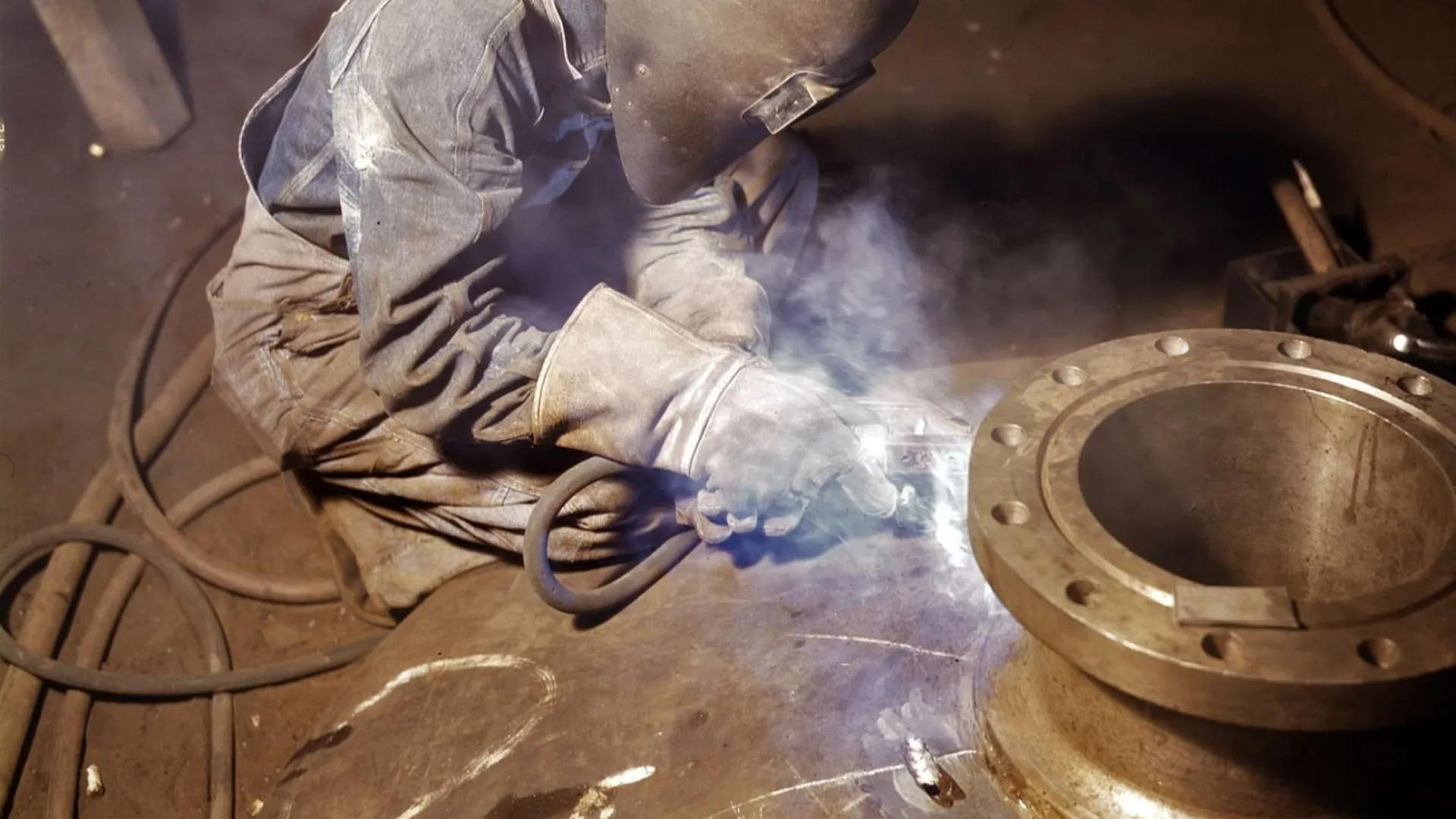 Close-up of person using a circular saw guide to make precise cuts on wood panels indoors
