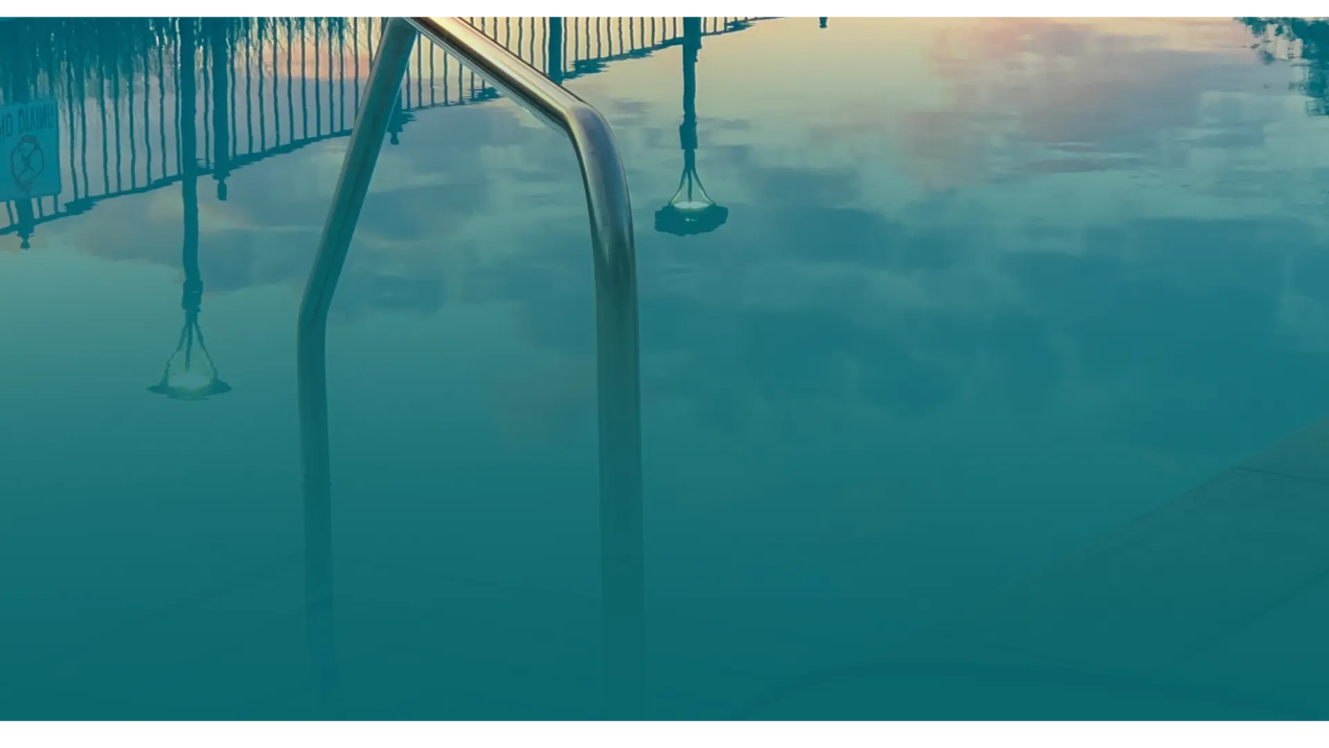 a reflection of a bridge in water