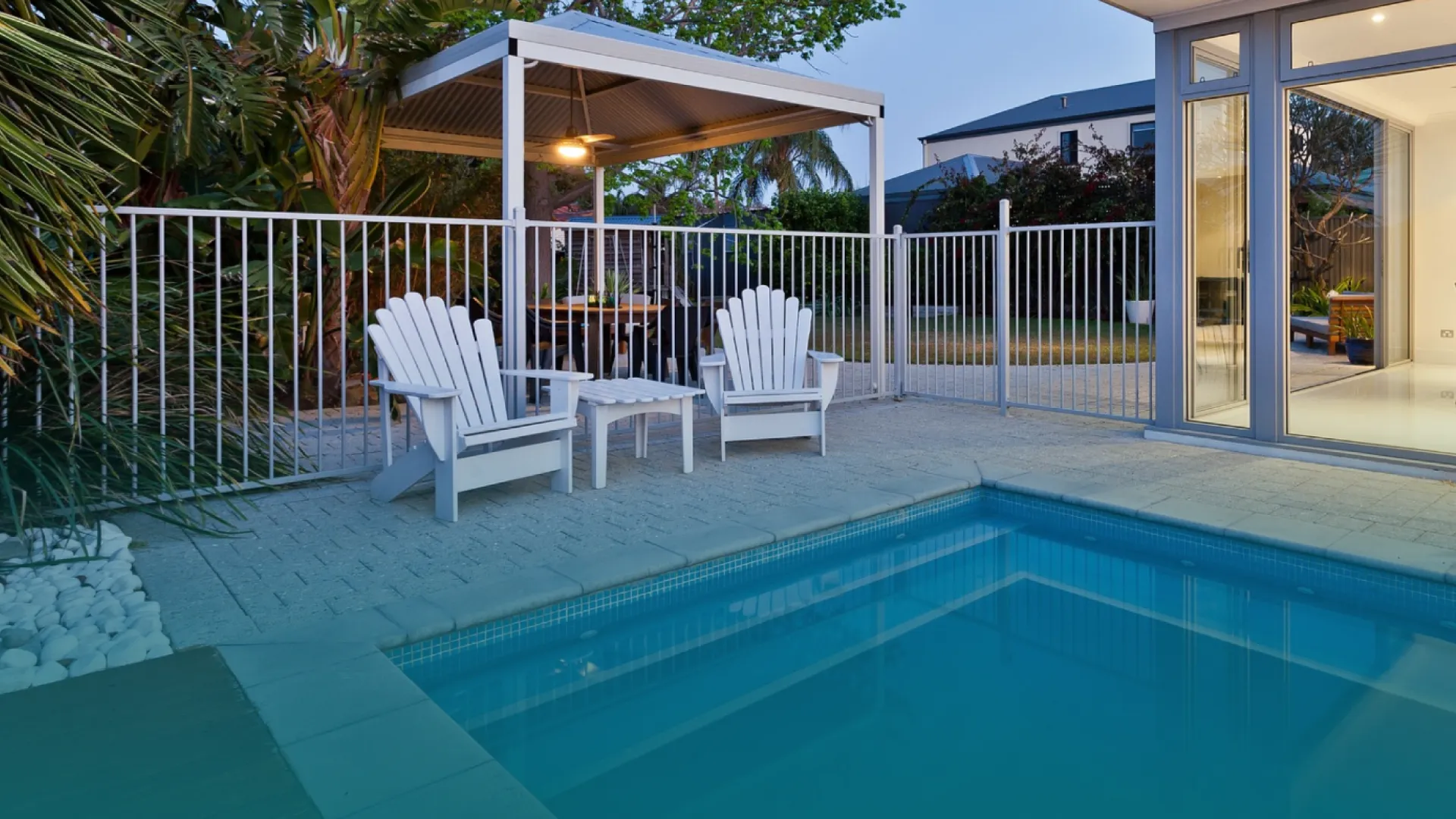 a pool with chairs and a deck