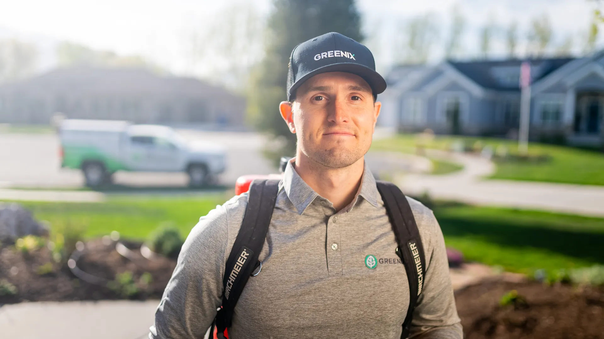 a man wearing a hat and standing outside