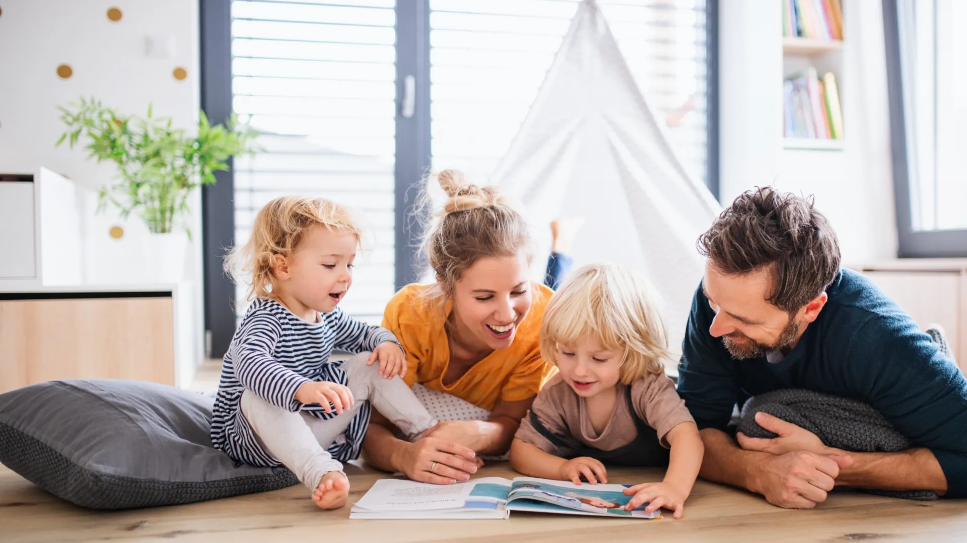 a person and a couple of children sitting on the floor