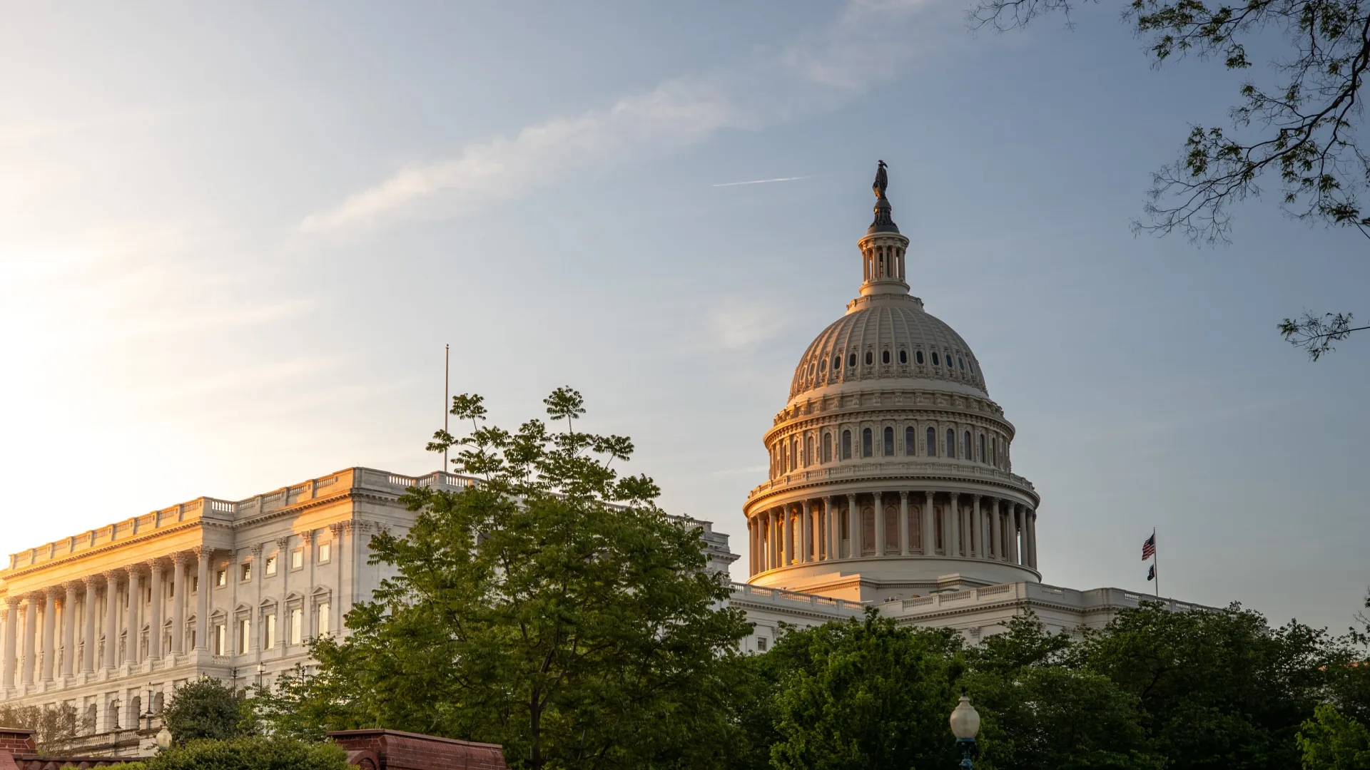 a large building with a domed roof with United States Capitol in the background