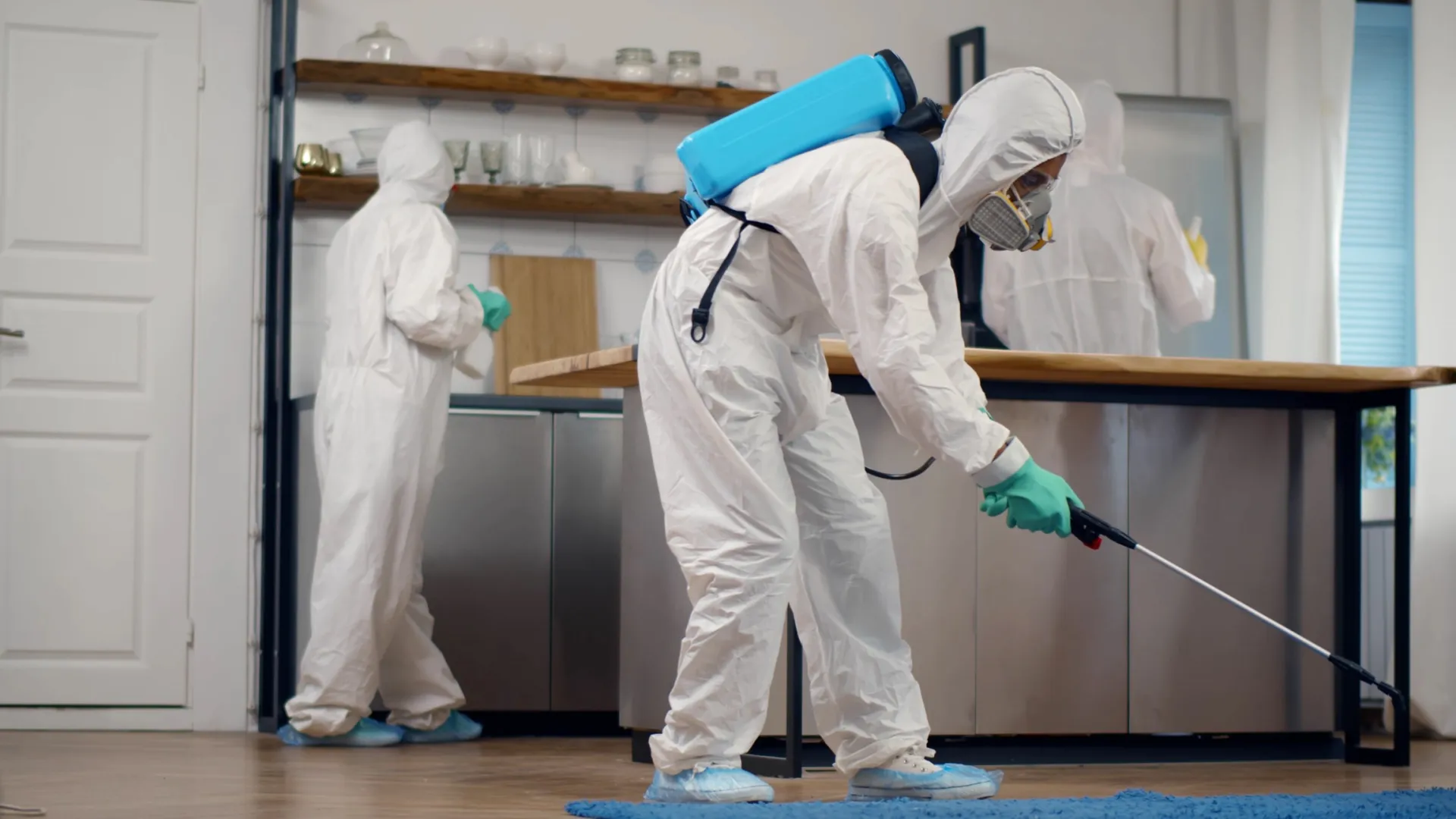 a few people wearing white lab coats and gloves and masks