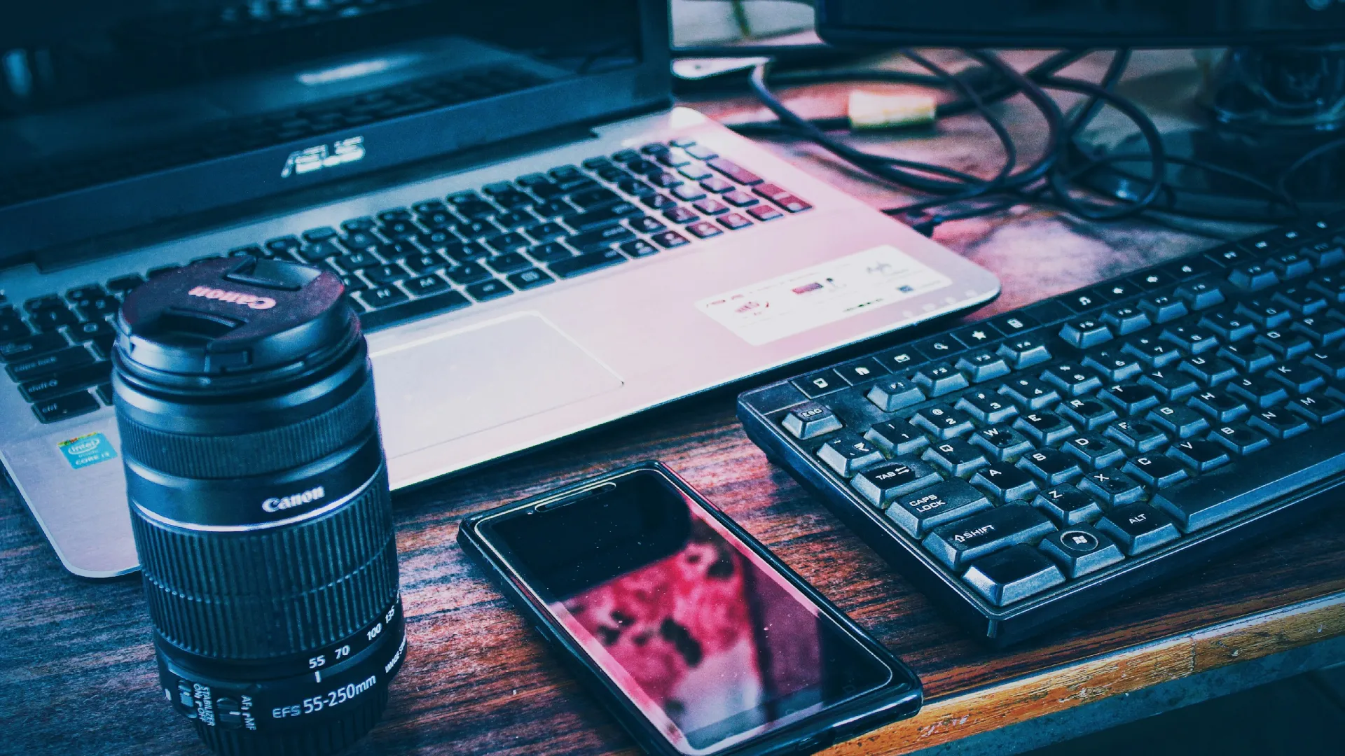 a laptop and a cell phone on a desk