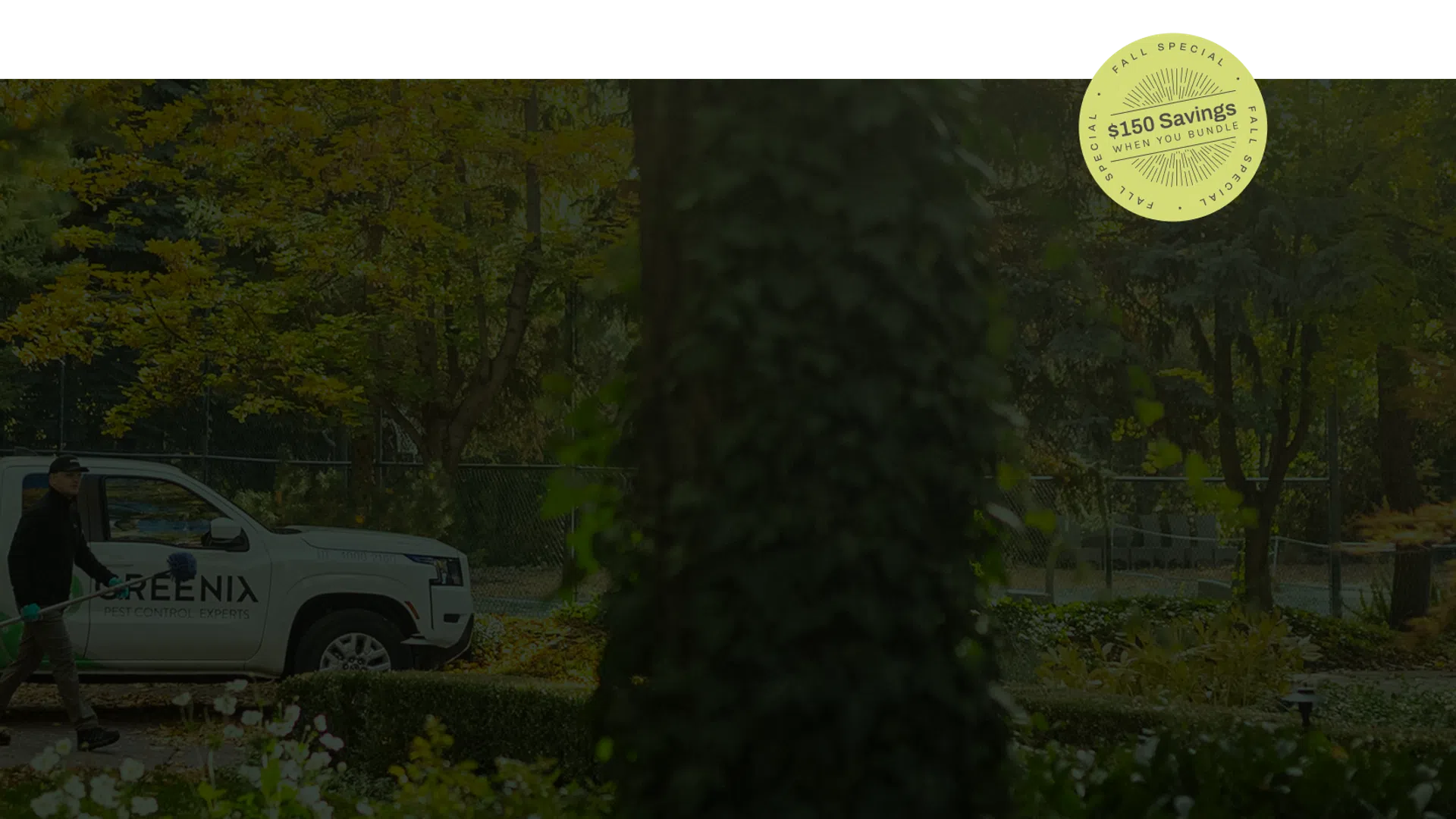 Greenix pest control technician walking with equipment near branded truck in a green outdoor garden.