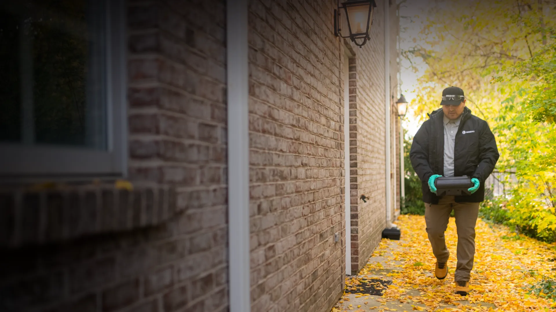 a man walking beside a house