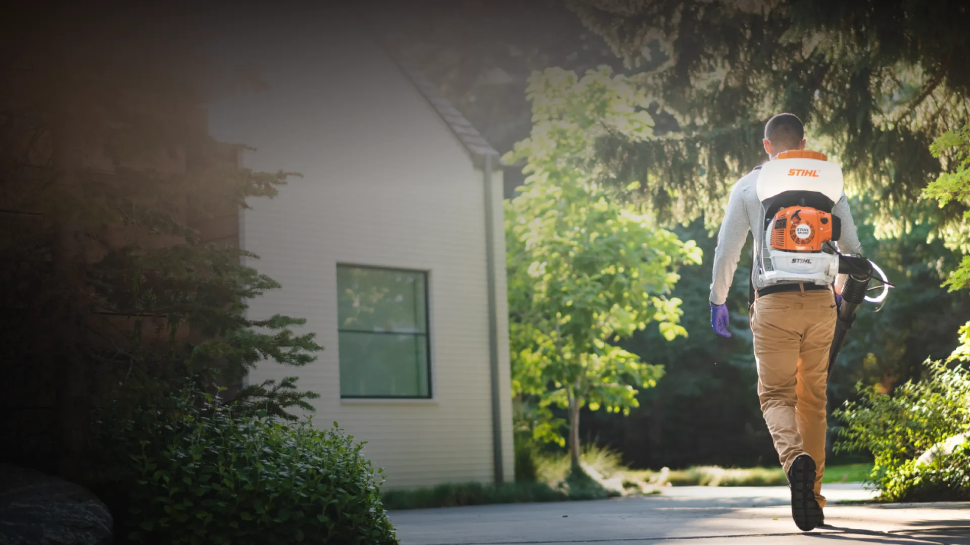 Pest Technician walking to house with tools