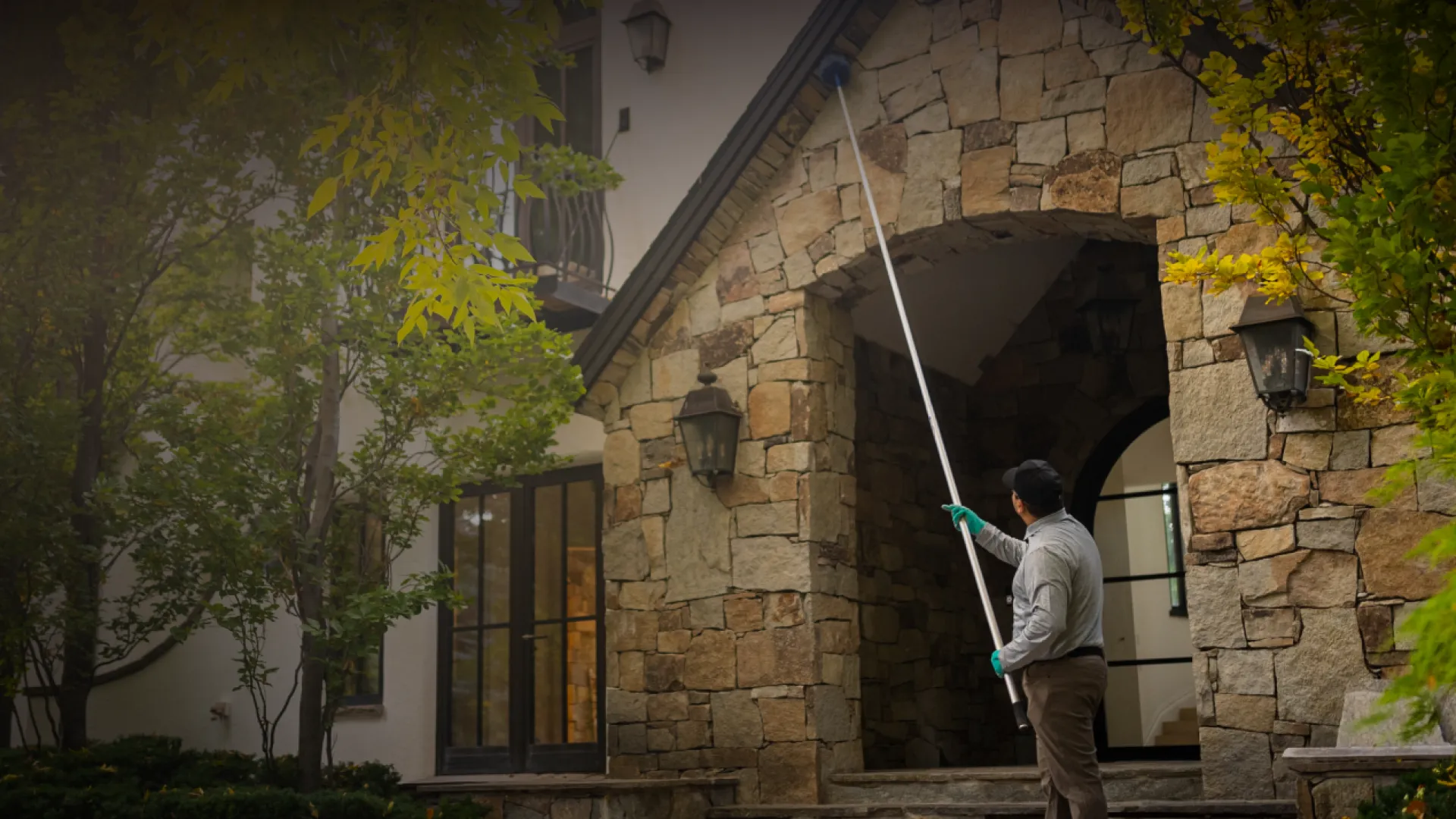 Pest Technician eave sweeping