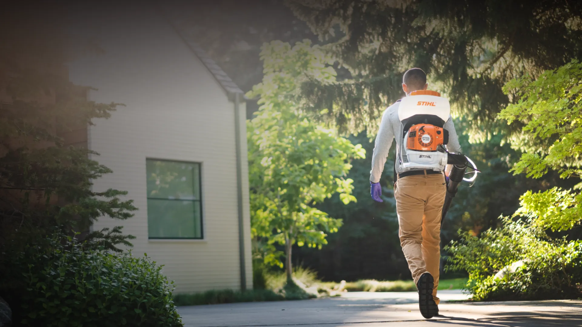 Pest Technician walking to house with tools