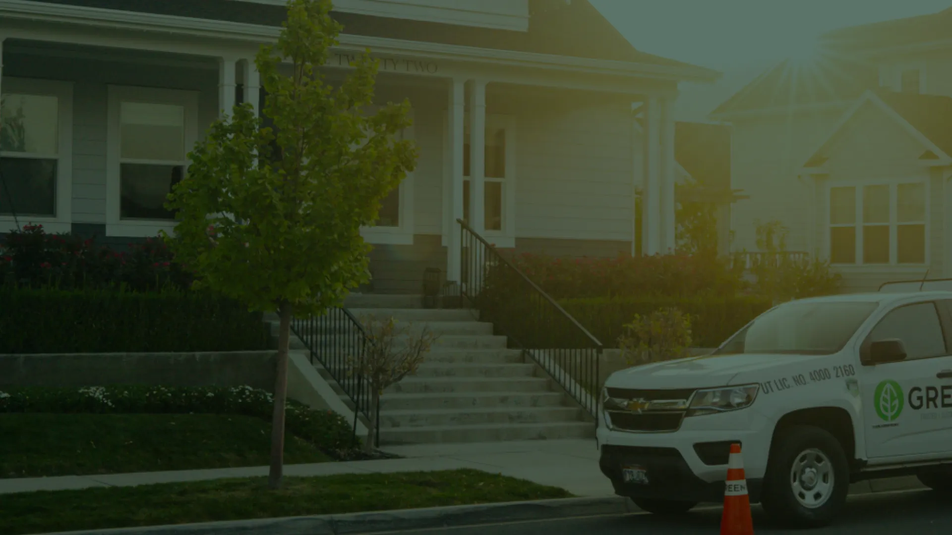 a greenix truck parked in front of a house