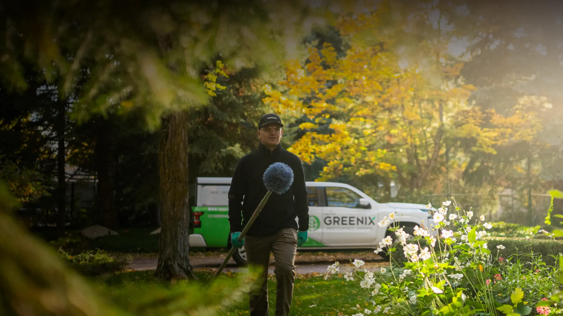 Pest Technician walking to house with tools