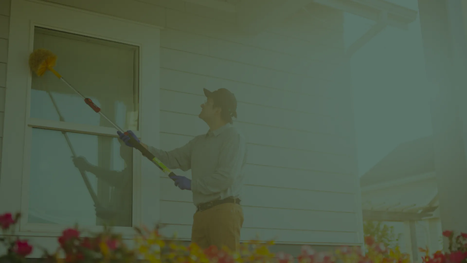 Pest Technician eave sweeping a window