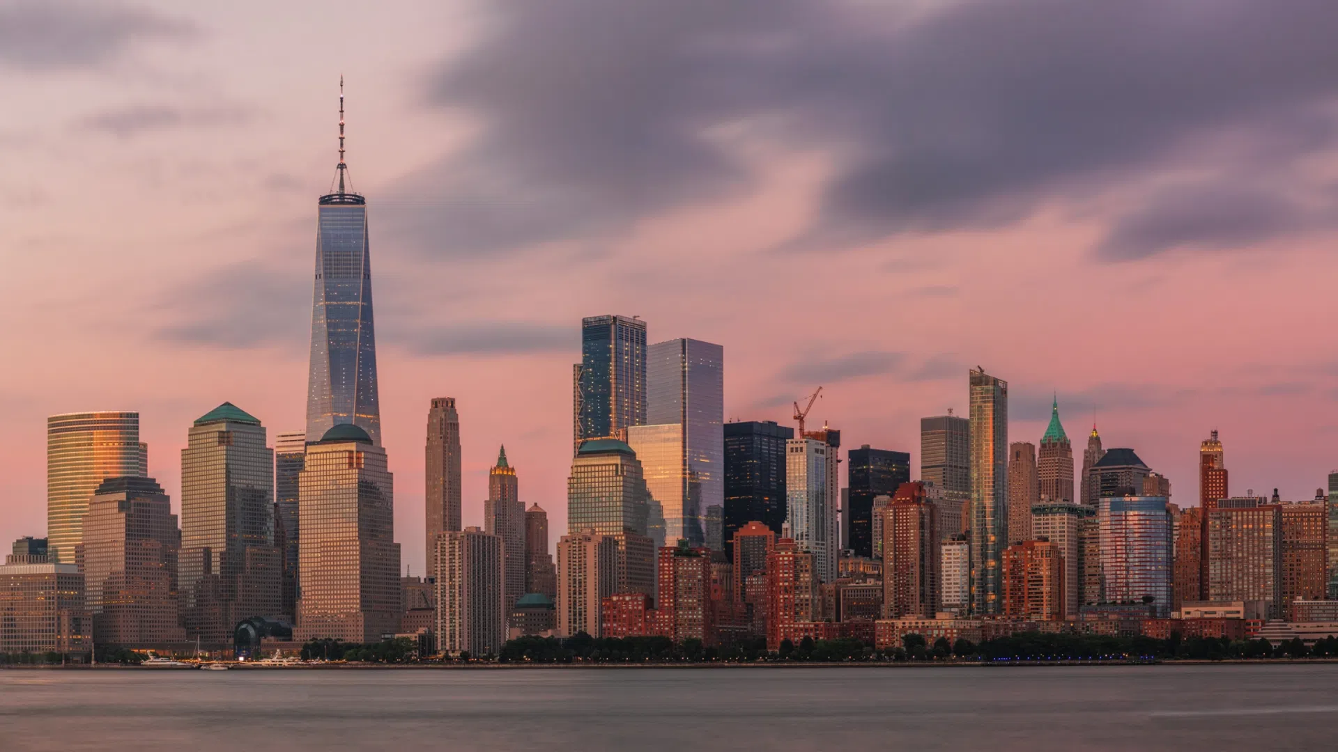 a city skyline with a body of water in the foreground