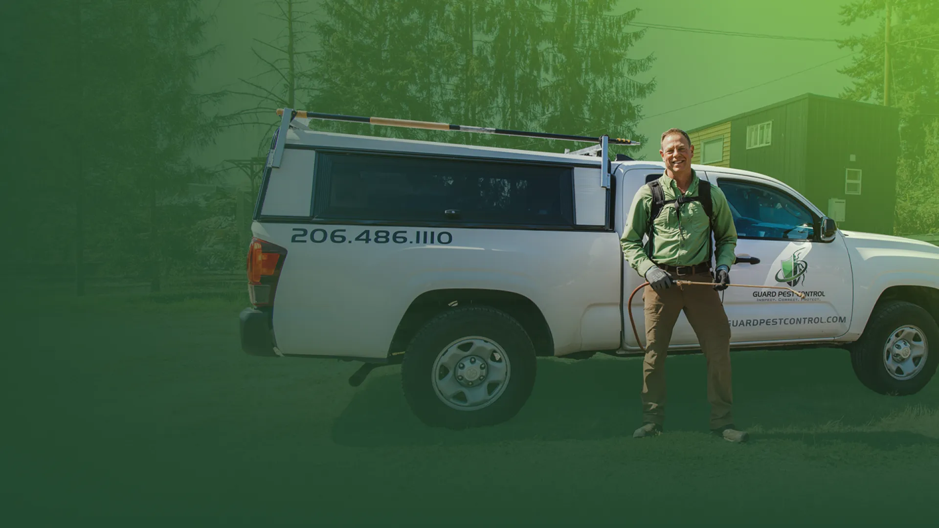 Pest control technician standing next to white service truck with company logo and phone number outdoors.