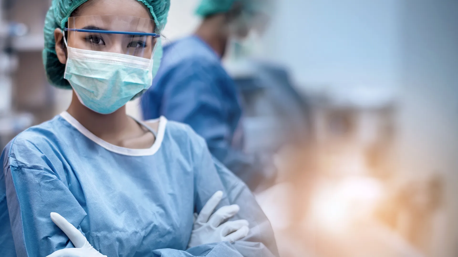 a surgeon wearing a face mask and shield