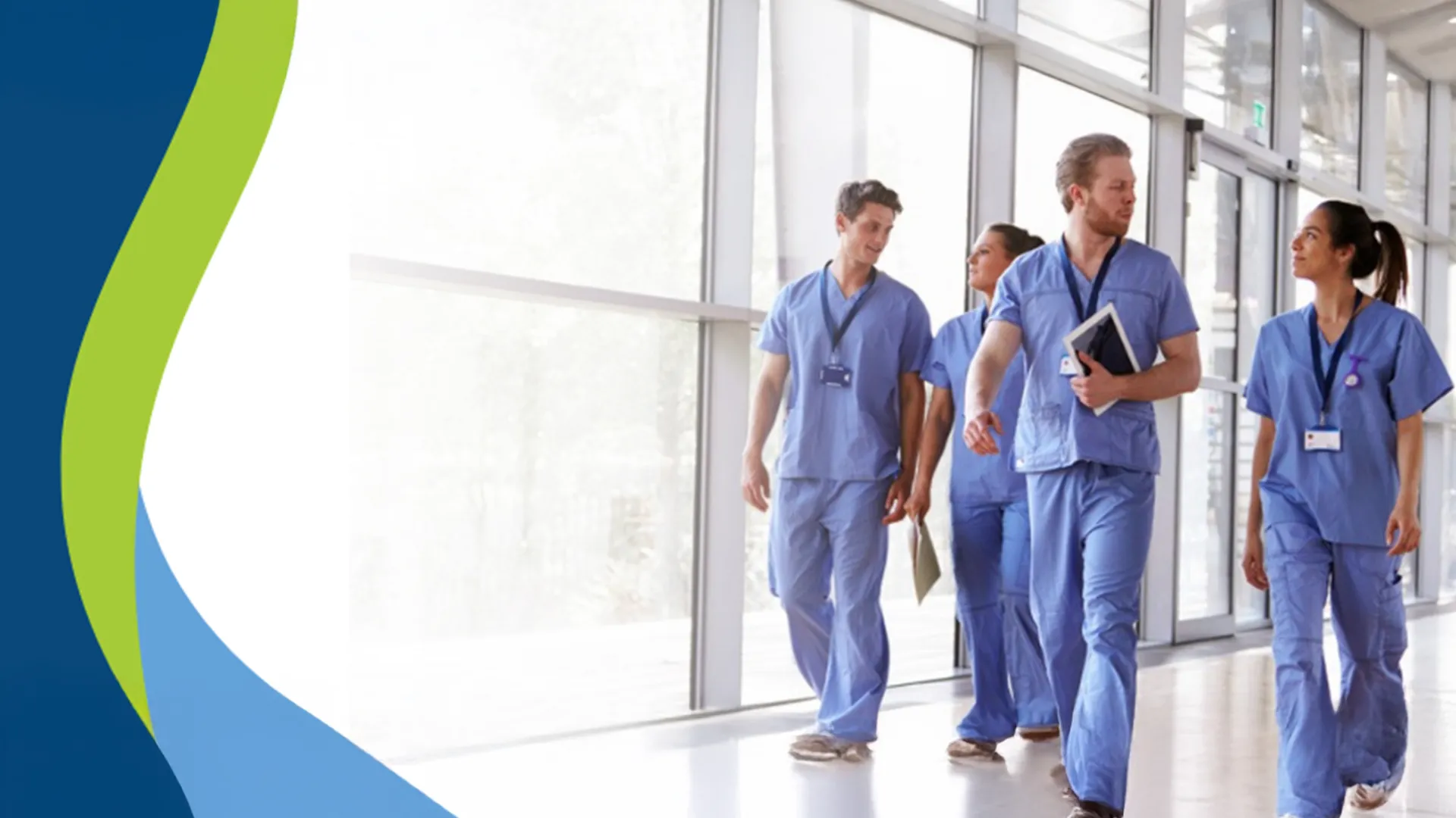 Group of diverse healthcare professionals walking and discussing in a bright hospital corridor.