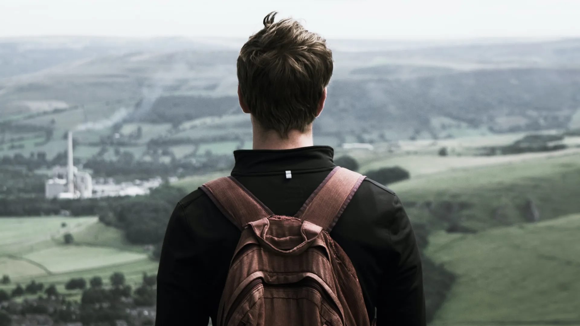 a person standing on top of a grass covered field