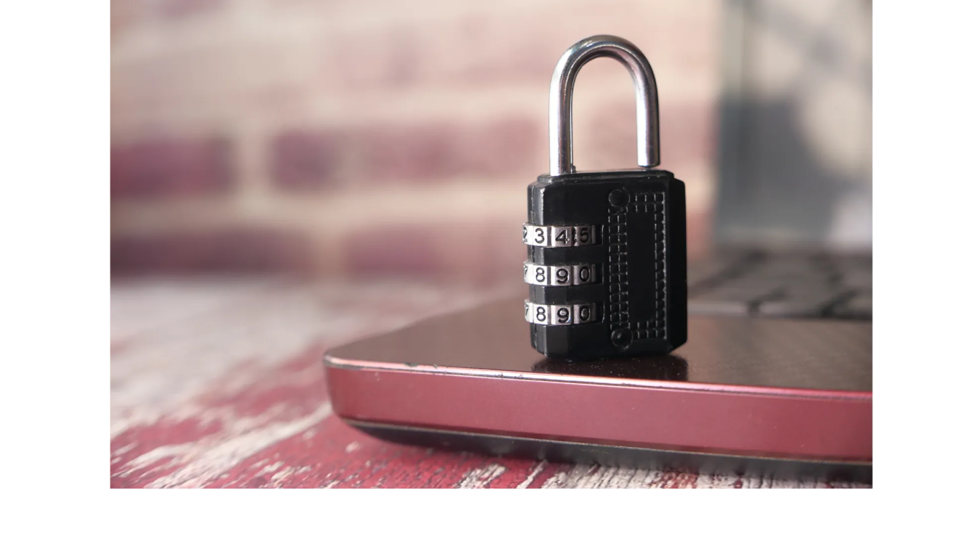 Combination padlock placed on a closed laptop representing digital security and data protection.