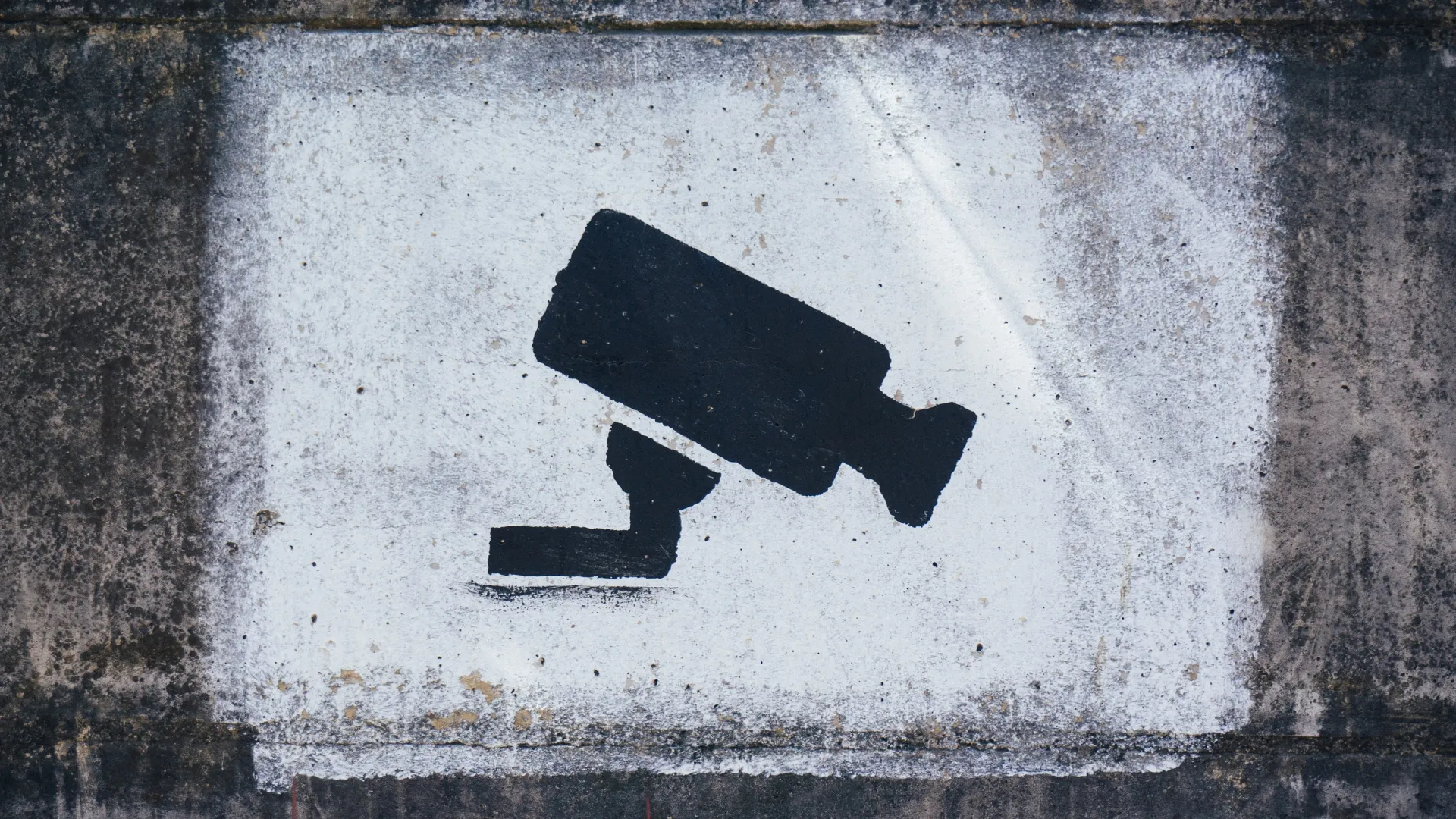 a close up of a cement bench sitting next to a brick wall