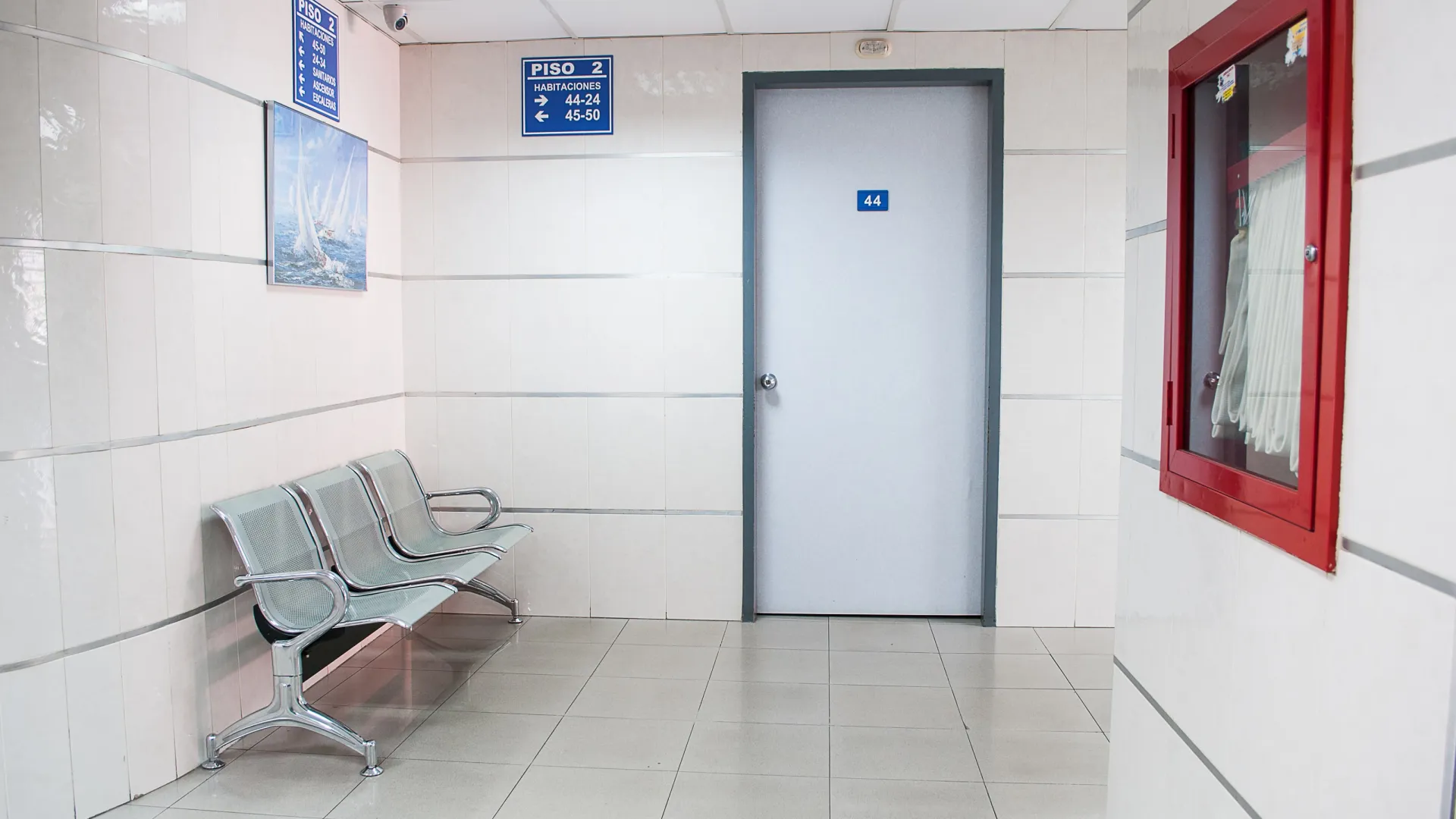 a clinical hospital hallway with public seats