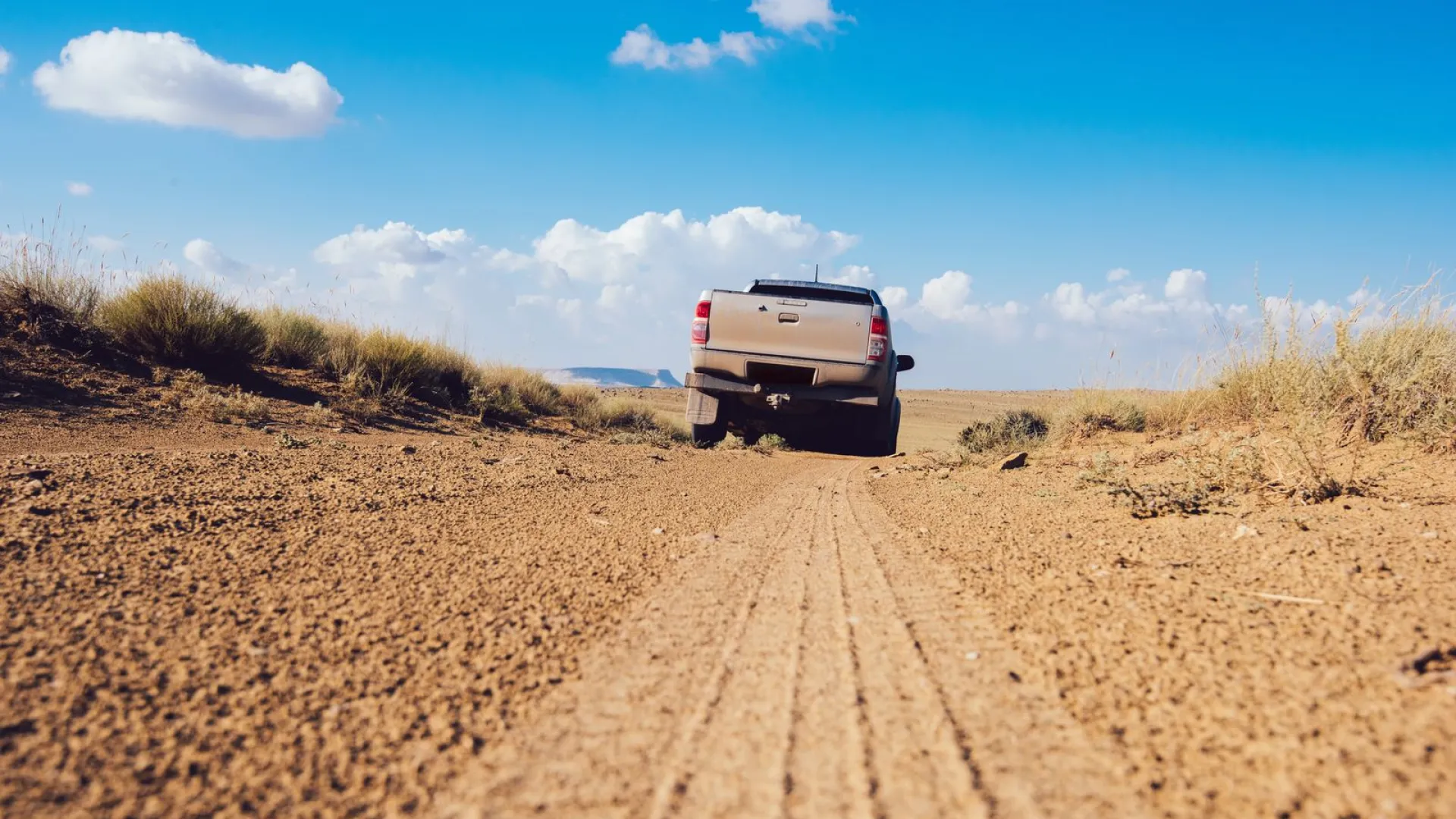 a car driving on a dirt road