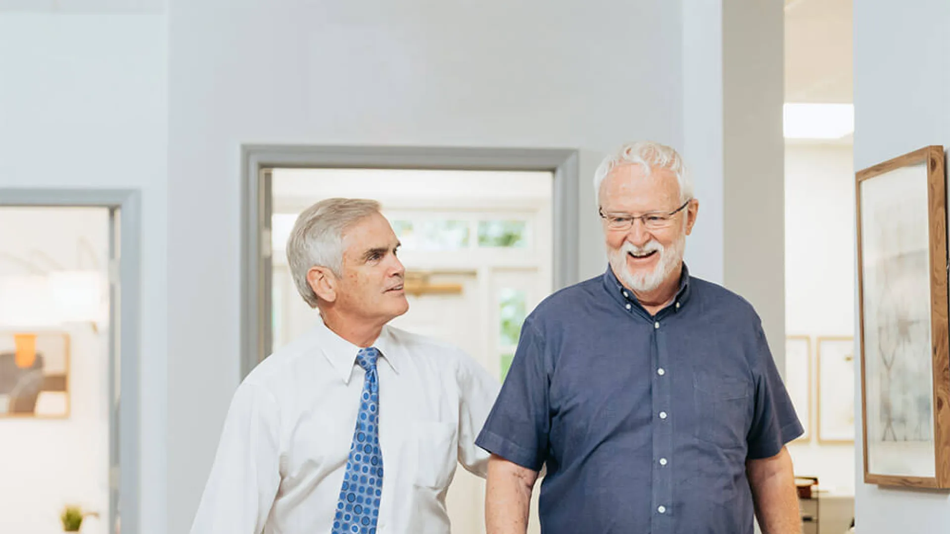 a couple of men standing in a room