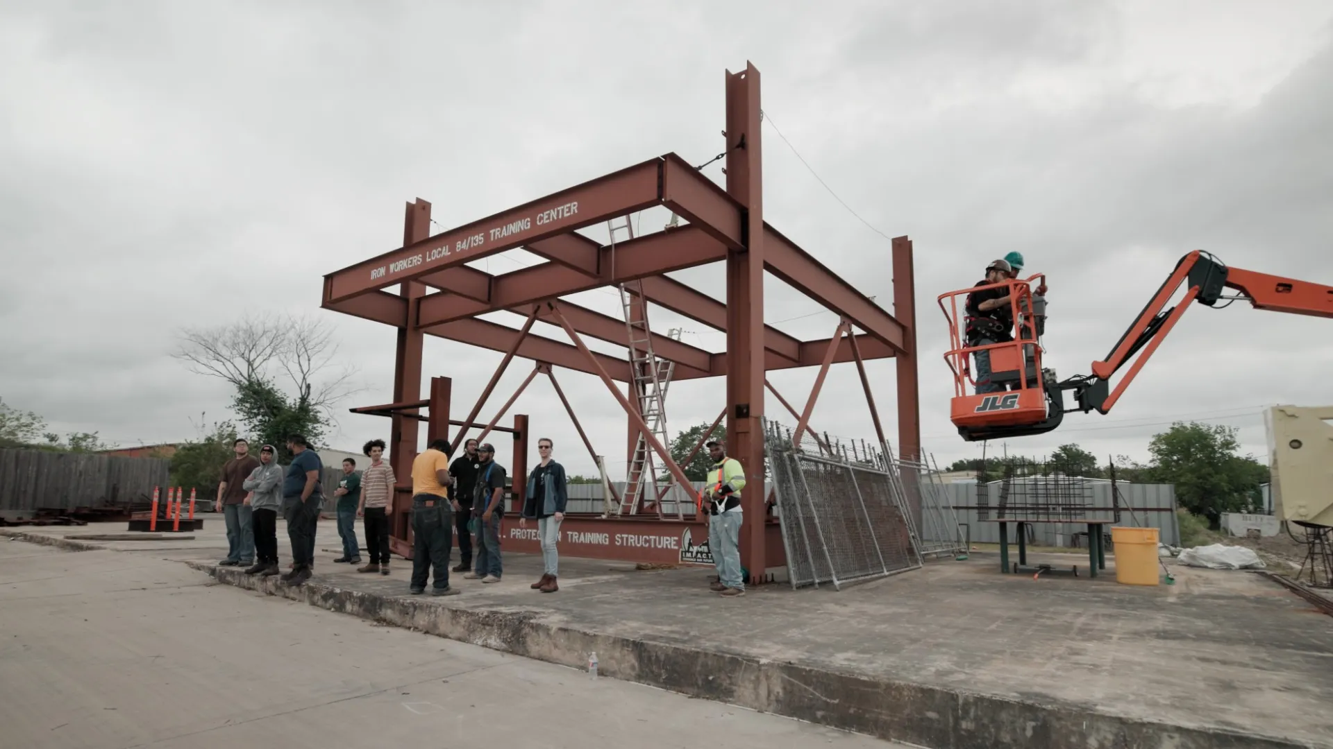 a group of people standing next to a construction site