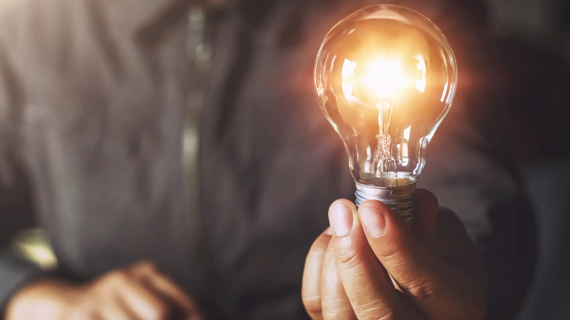 a person holding a light bulb