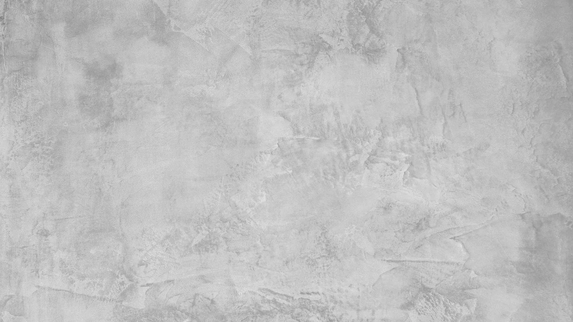 Textured gray concrete wall background with subtle patterns and natural imperfections.