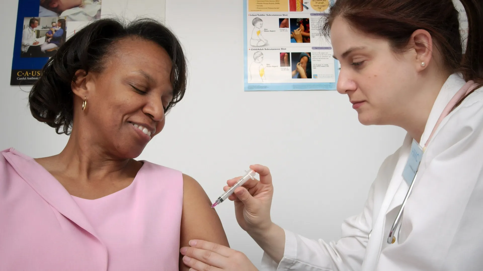 a doctor showing a patient something on the phone