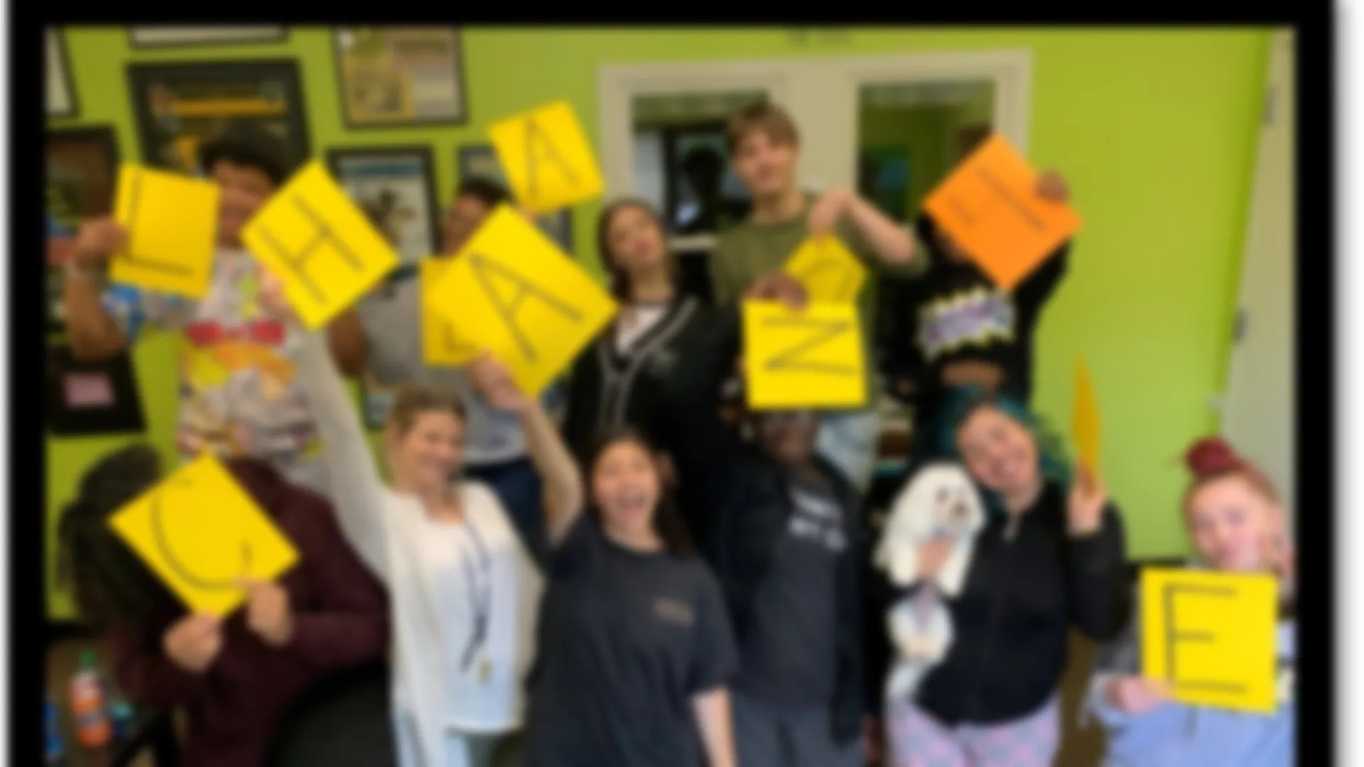 a group of people holding yellow signs