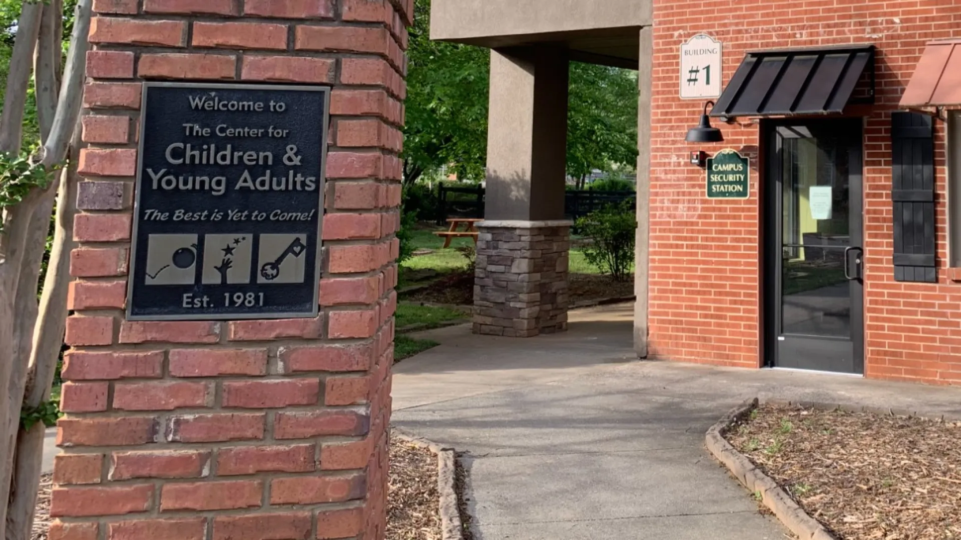 a brick building with a sign