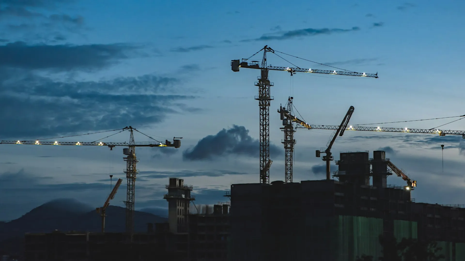 a group of cranes next to a building