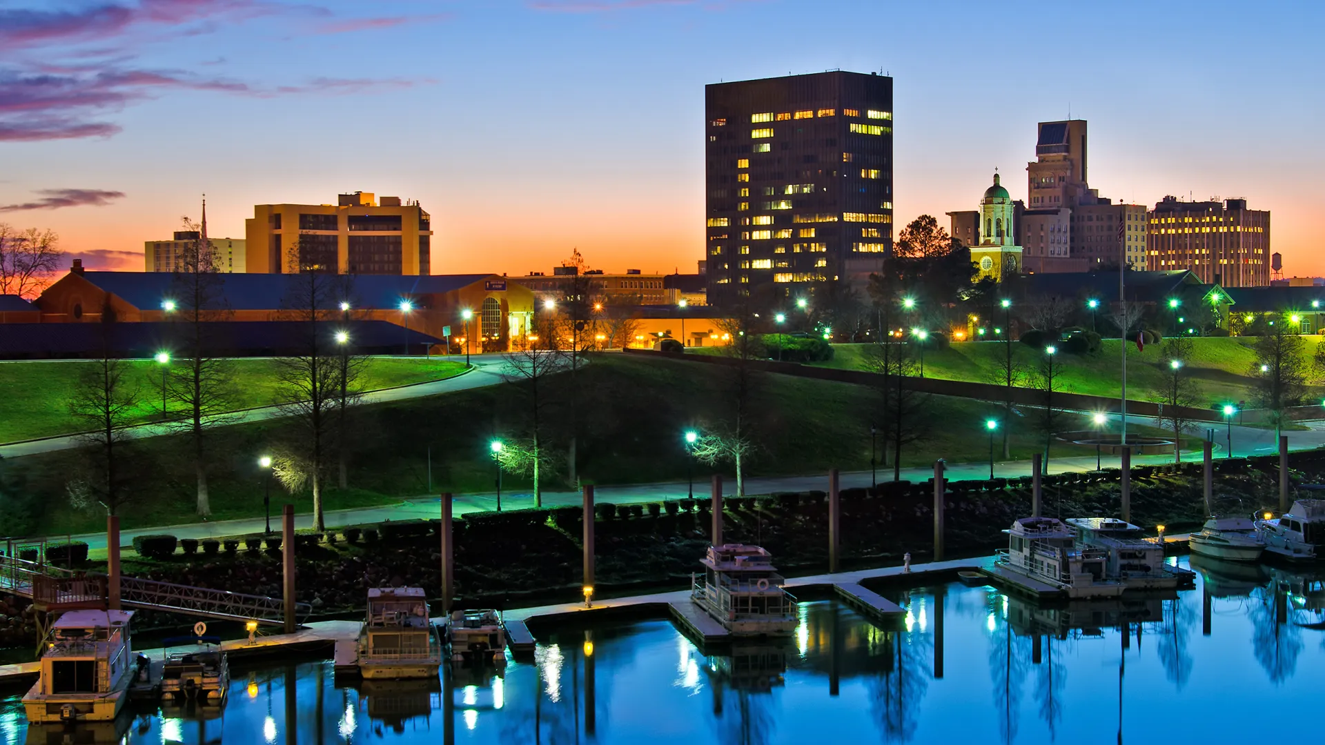 a small boat in a body of water with a city in the background