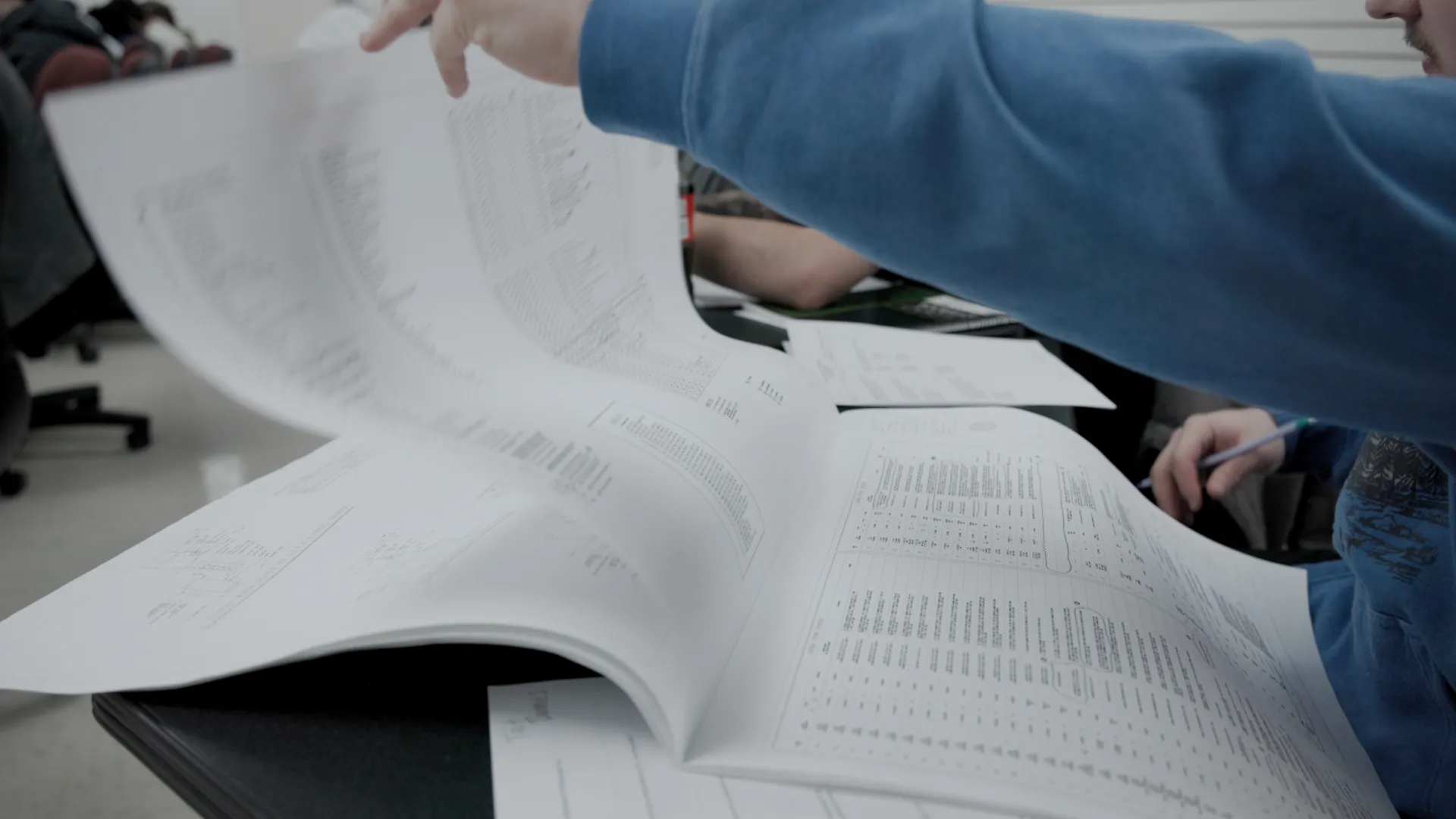 a person writing on a piece of paper