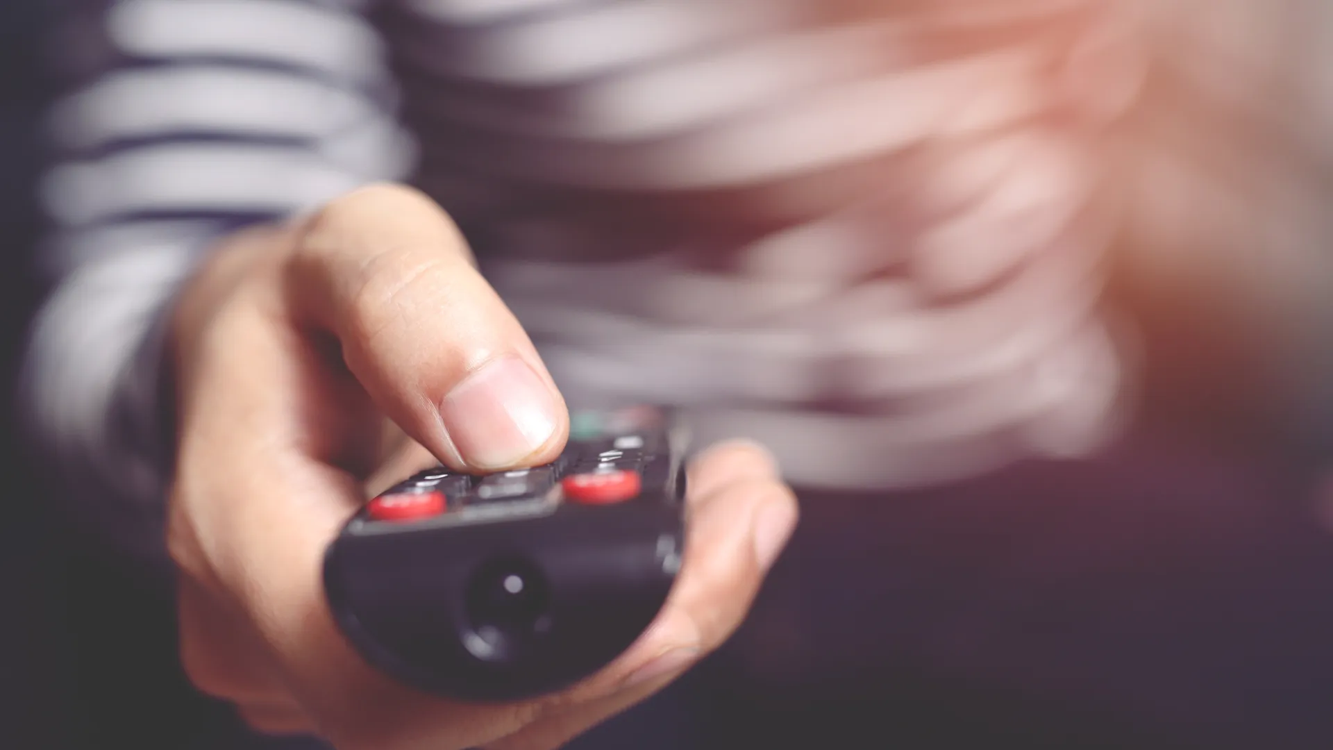 a person holds a remote control