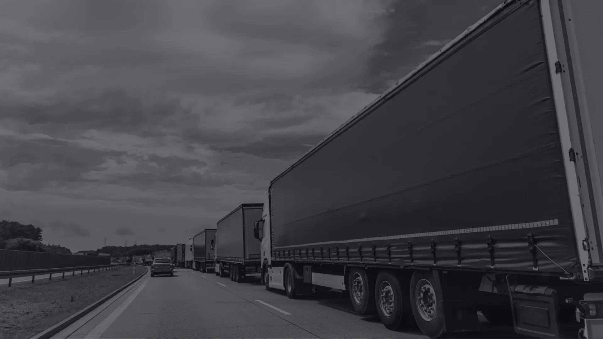 Man in reflective vest inspecting a damaged truck stuck off-road next to construction equipment on a dirt path