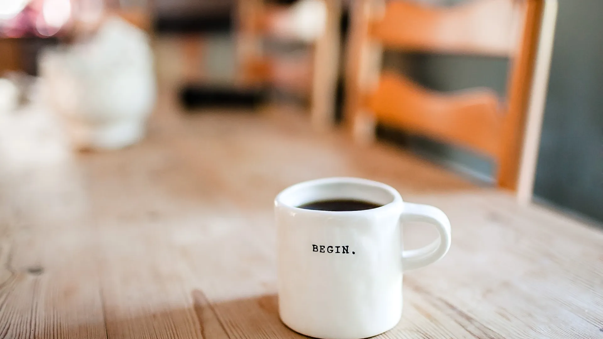 a close up of a coffee cup sitting on top of a wooden table