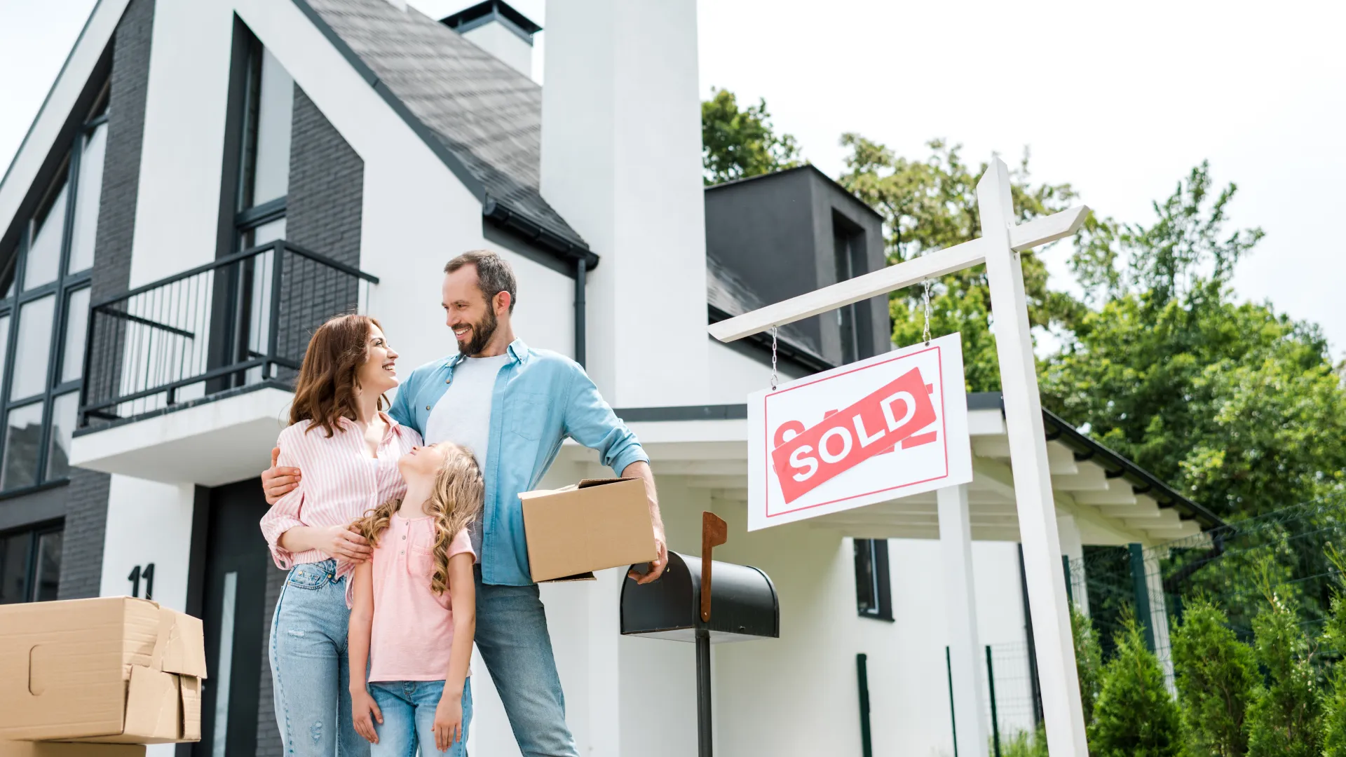 a family standing in front of a house