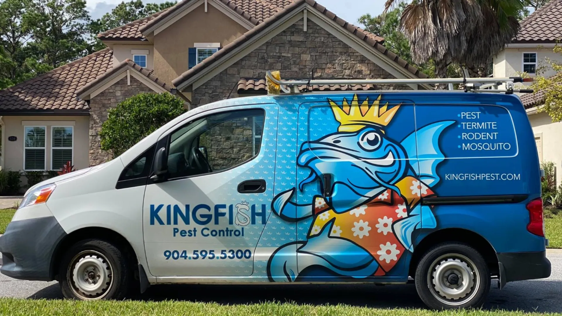 a Kingfish Pest Control truck parked in front of a house