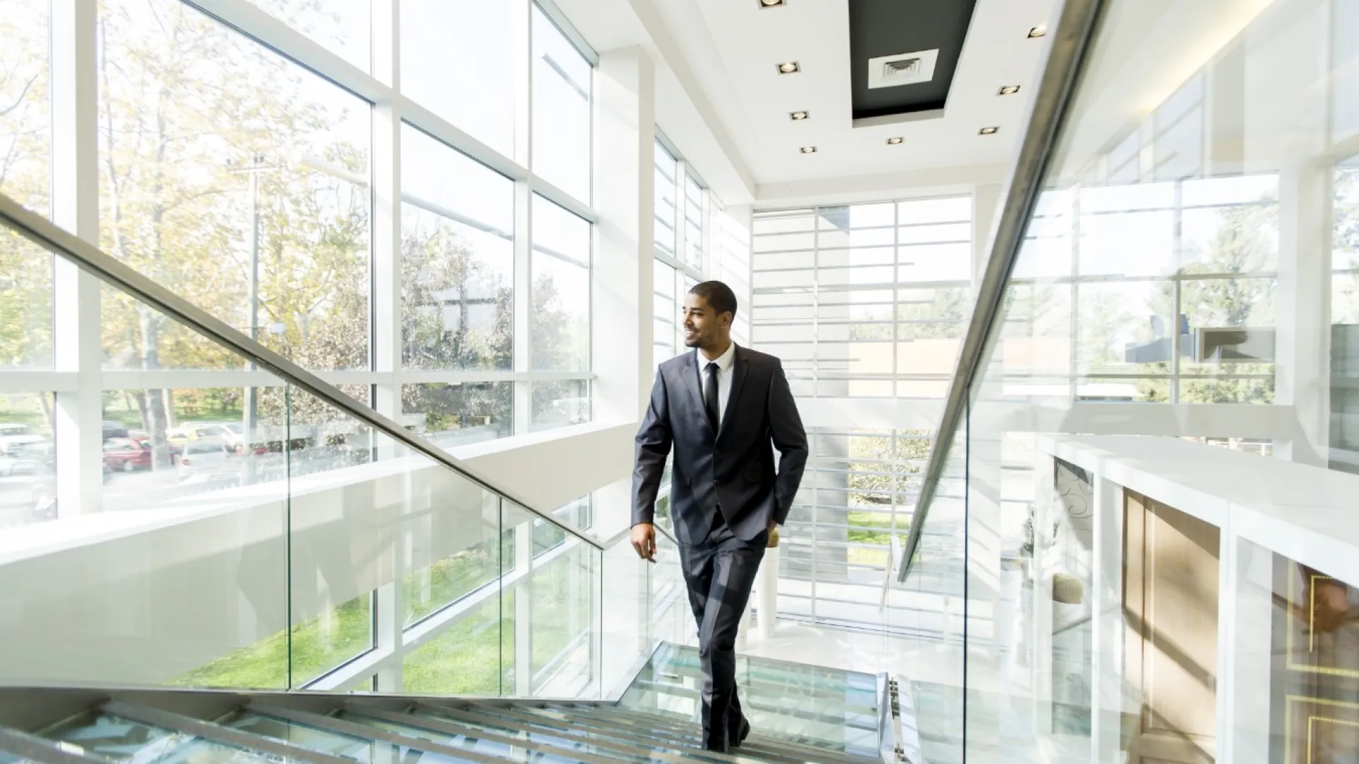 a man standing next to a window