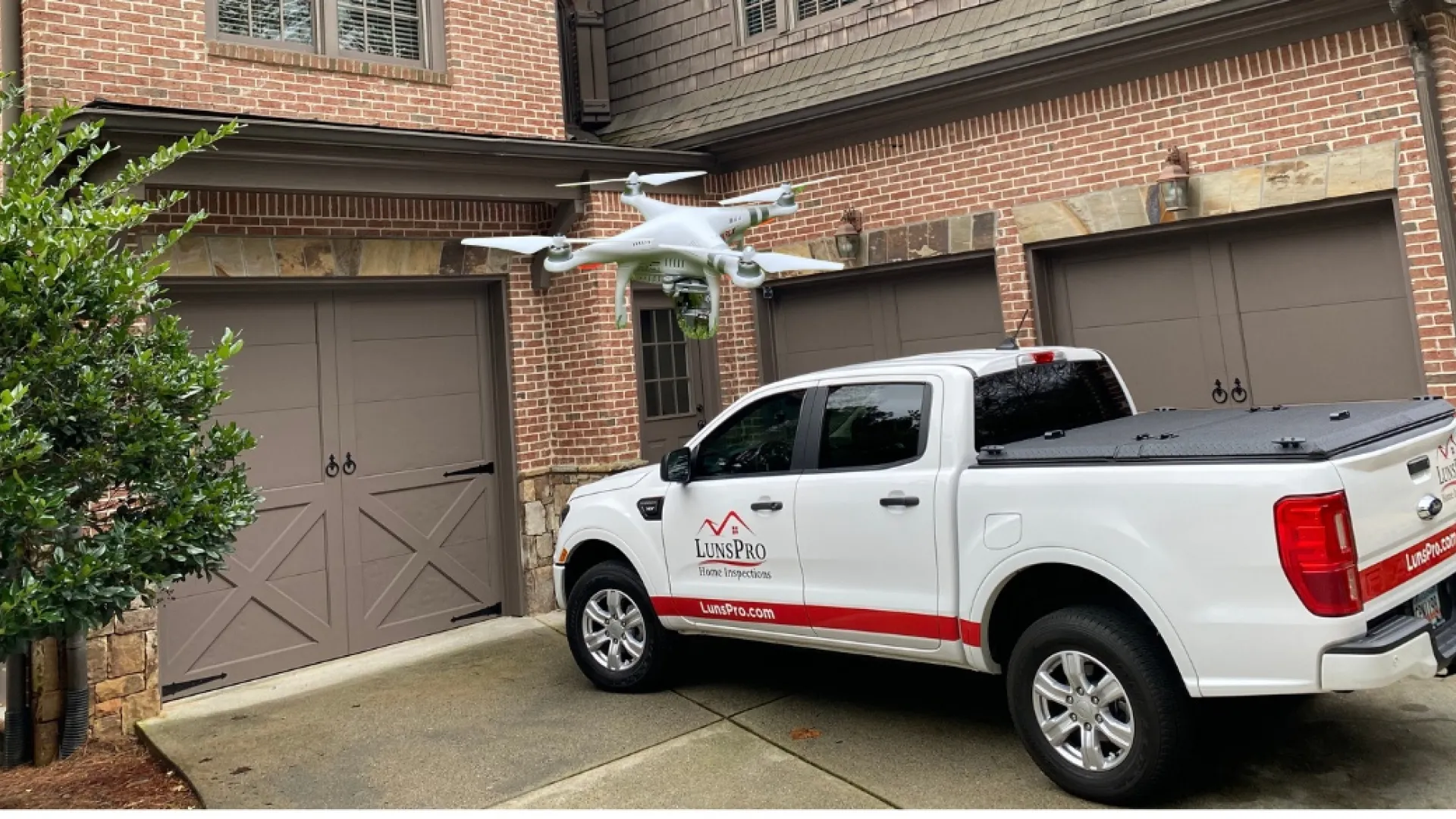 a white truck parked in front of a brick building