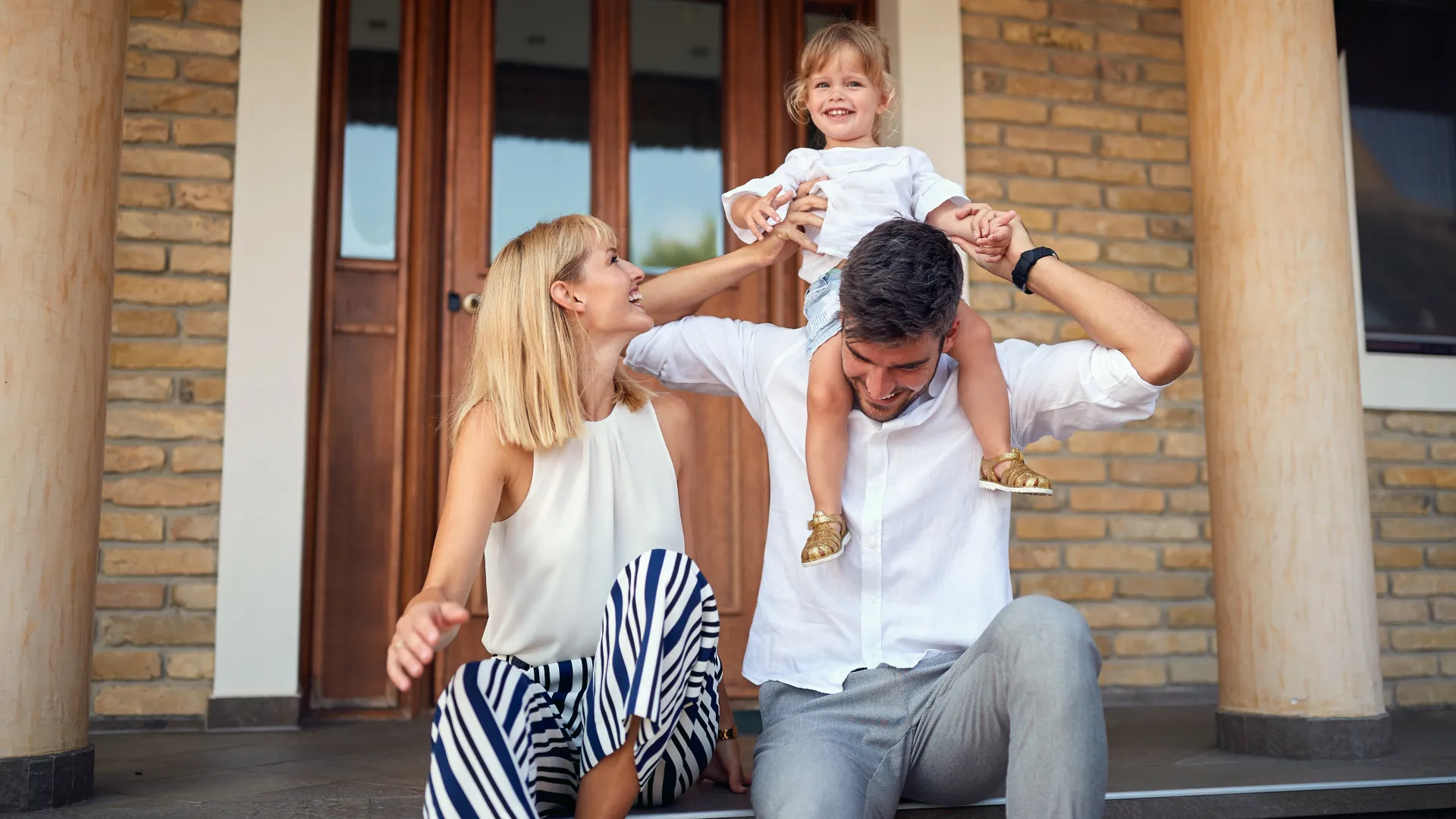 a family in front of a house