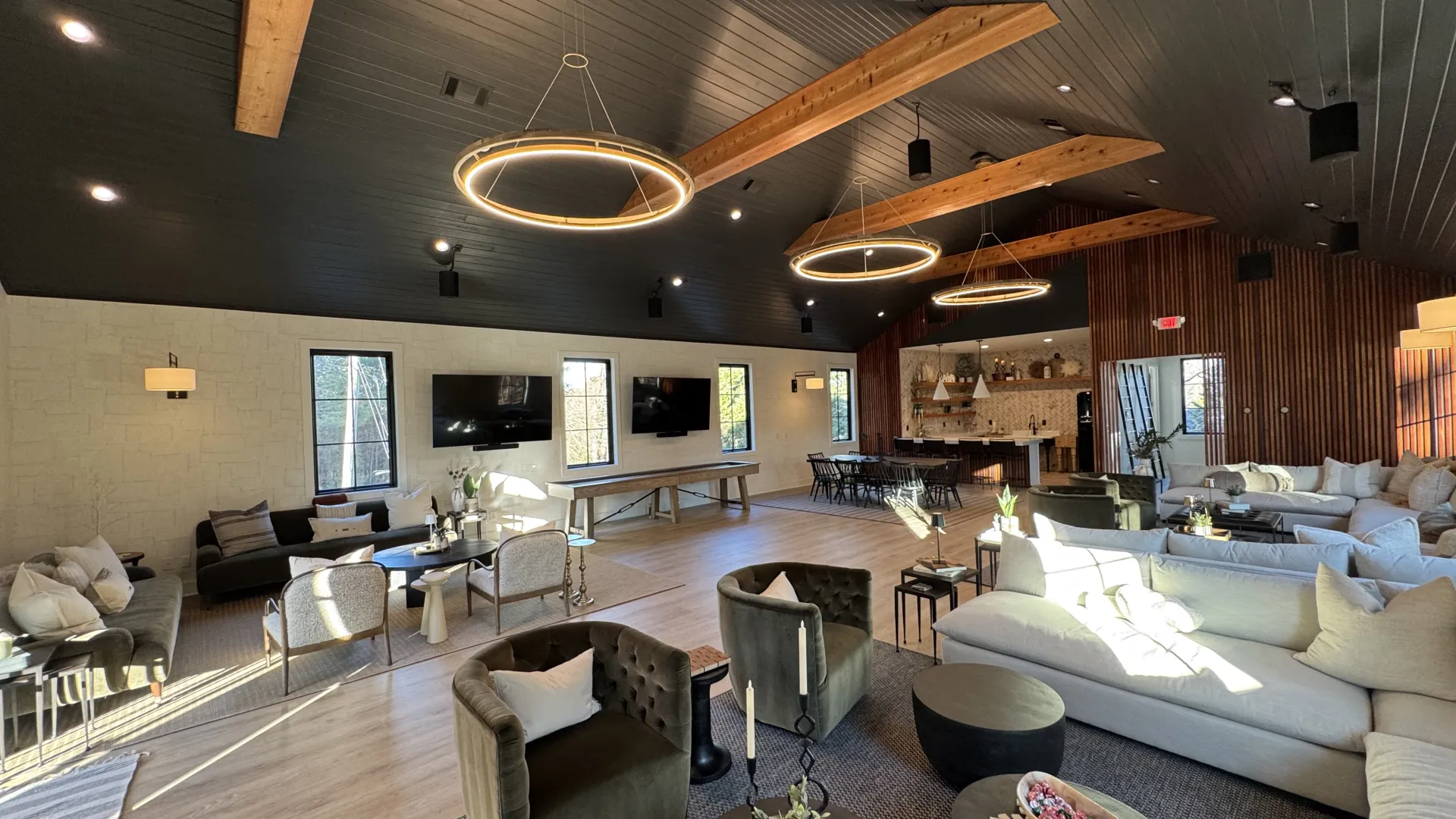 a large living room with a large chandelier and a large wood ceiling