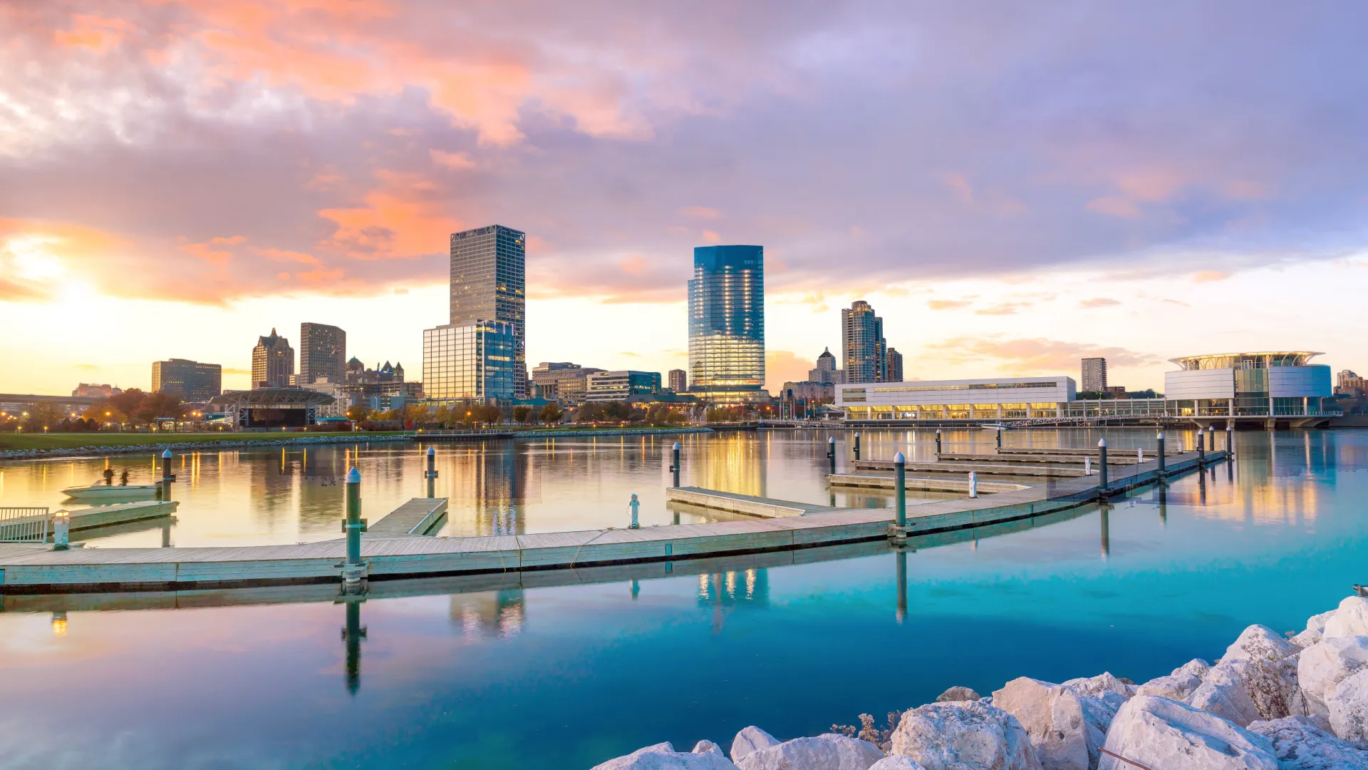 a city skyline with a body of water in the foreground