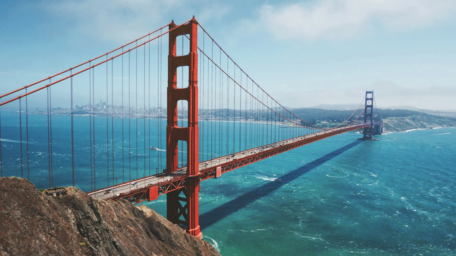 a large red bridge over water