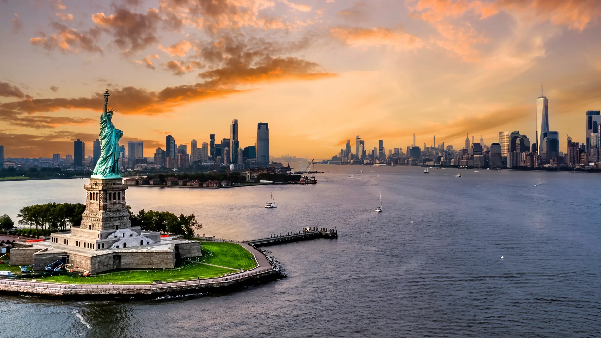 a statue on a island with a city in the background